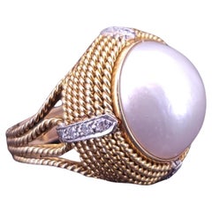Cassis white pearl and diamond cocktail ring set in 18k yellow gold.