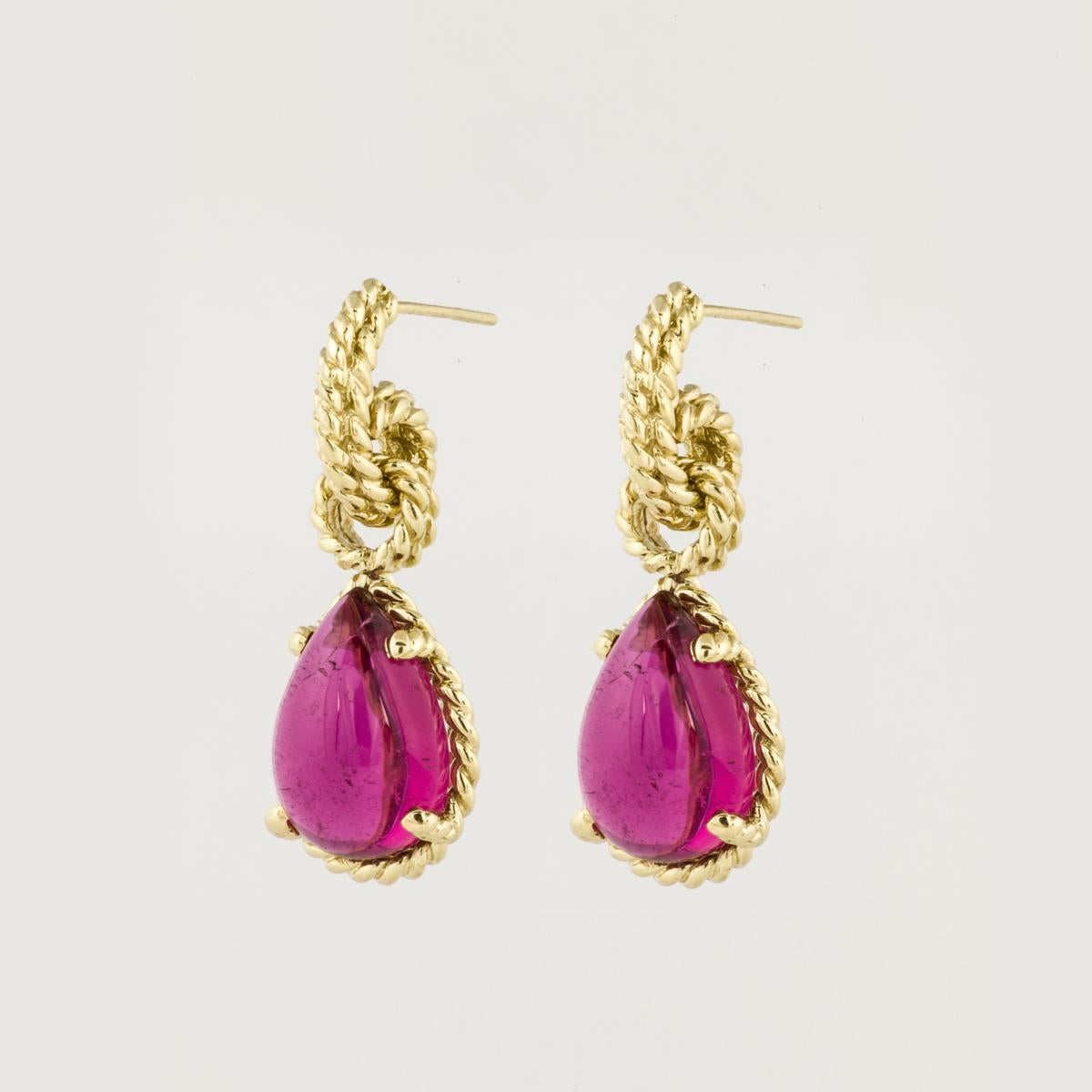 18K yellow gold pink tourmaline drop earrings by Cassis.  The pear-shaped cabochon pink tourmaline are set in a rope design, and the earrings measure 1 1/4 inches long and 1/2 inch wide.  They are made for pierced ears with post and clutch back.