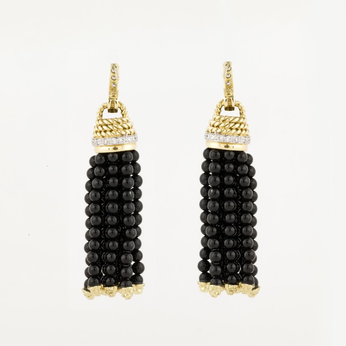 18K yellow and white gold earrings by Cassis.  The tassels are black onyx beads with gold caps at the ends, with diamonds set in white gold.  The round diamonds total 0.76 carats, G-H color and VS clarity.  The earrings measure 2 1/2 inches long and