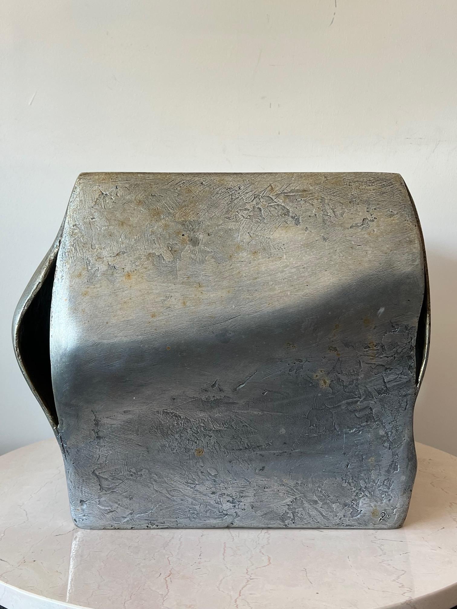 An unusual cast aluminum sculpture by Anne Van Kleeck (1922-1998). A bulging cube, patinated and polished top, that can be a pedestal or side table, unsigned, numbered 2. From the artist's estate. A note about the artist: Anne Van Kleeck was