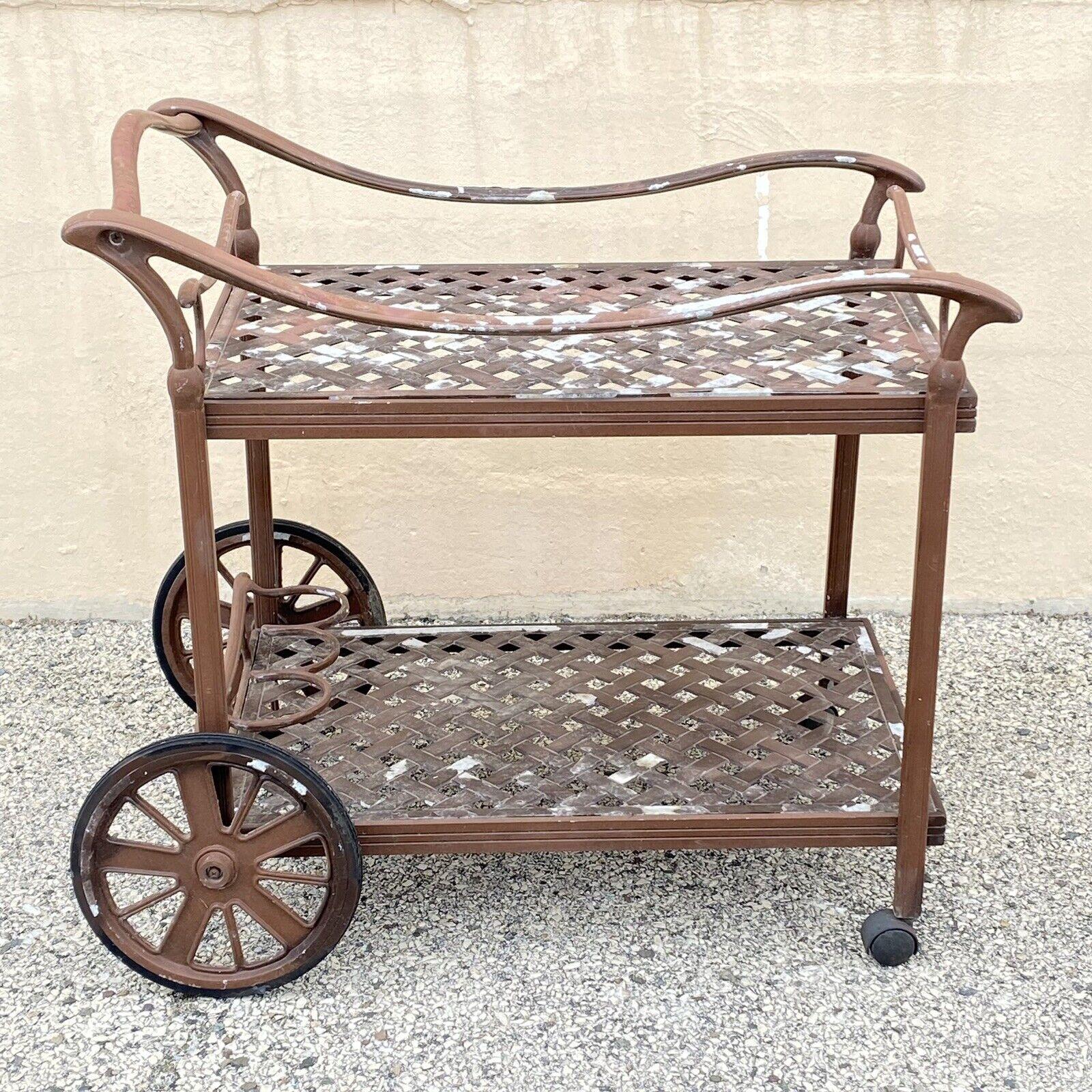 Cast Aluminum Garden Patio Terrace Rolling Serving Bar Table Pool Tea Cart. Item features a heavy cast aluminum construction, removable serving tray with handles, 2 tiers, rolling wheels, great style and form. Circa Late 20th - 21st Century.