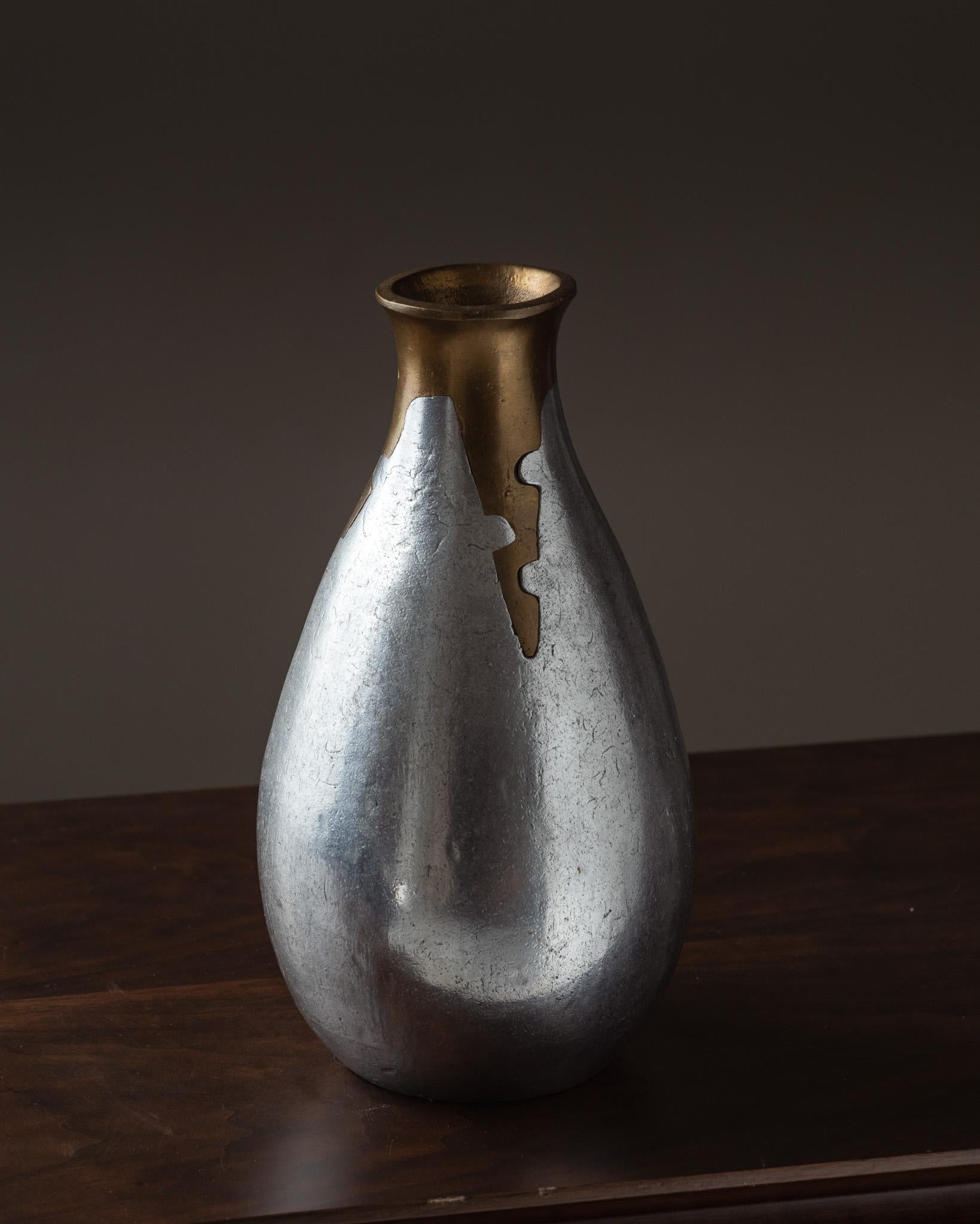 Vase by Philippe Jean, 1970s.
Oblong form resembling a tub, with a wide body and narrow neck. Made of cast aluminum with a bronze inset at the neck. Excellent condition.

DV4462