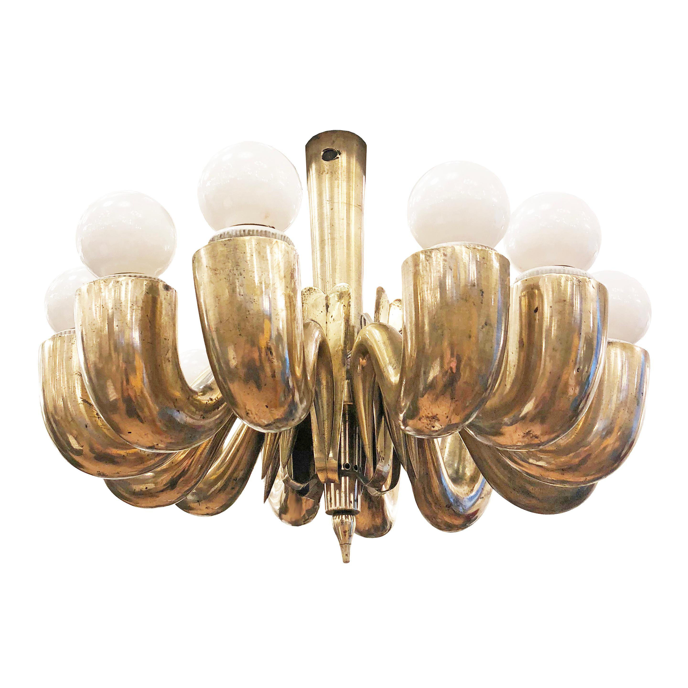 Diminutive midcentury chandelier attributed to Gugliemo Ulrich composed of 12 sloping cast brass arms each holding one E26 socket. To be hung on a chain.

Condition: Good vintage condition, minor wear and marks throughout.

Measure: Diameter