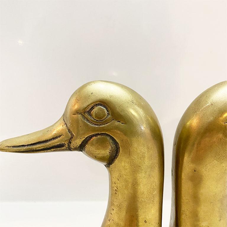 For the savvy bookshelf stylist, this pair of cast brass duck or mallard head book ends will bring a midcentury feel to any bookshelf. This pair is very sturdy and heavy. Great for holding up books on a bookshelf, or for decor on an entry table.