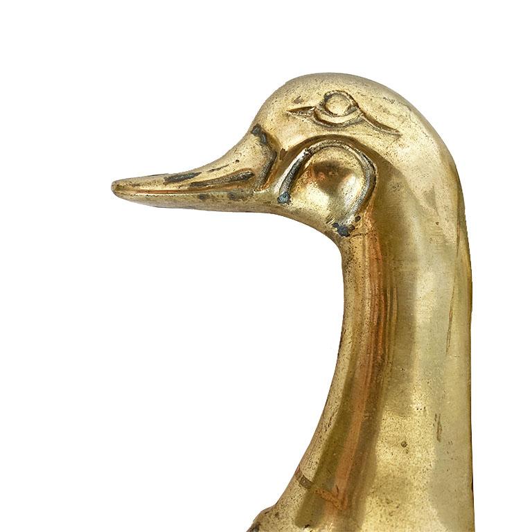 For the savvy bookshelf stylist, this pair of cast brass duck or mallard head bookends will bring a midcentury feel to any bookshelf. This pair is very sturdy and heavy. Great for holding up books on a bookshelf, or for decor on an entry table.