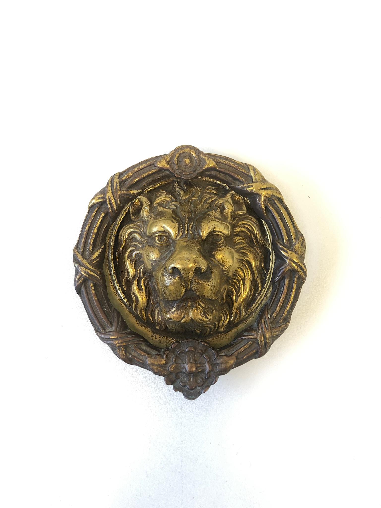 1970s large cast brass Lion head with wreath door knocker.
As found condition with aged brass patina. It can be polished if desired.
Measurements: 9.75” high, 9” wide and 2.75” deep.