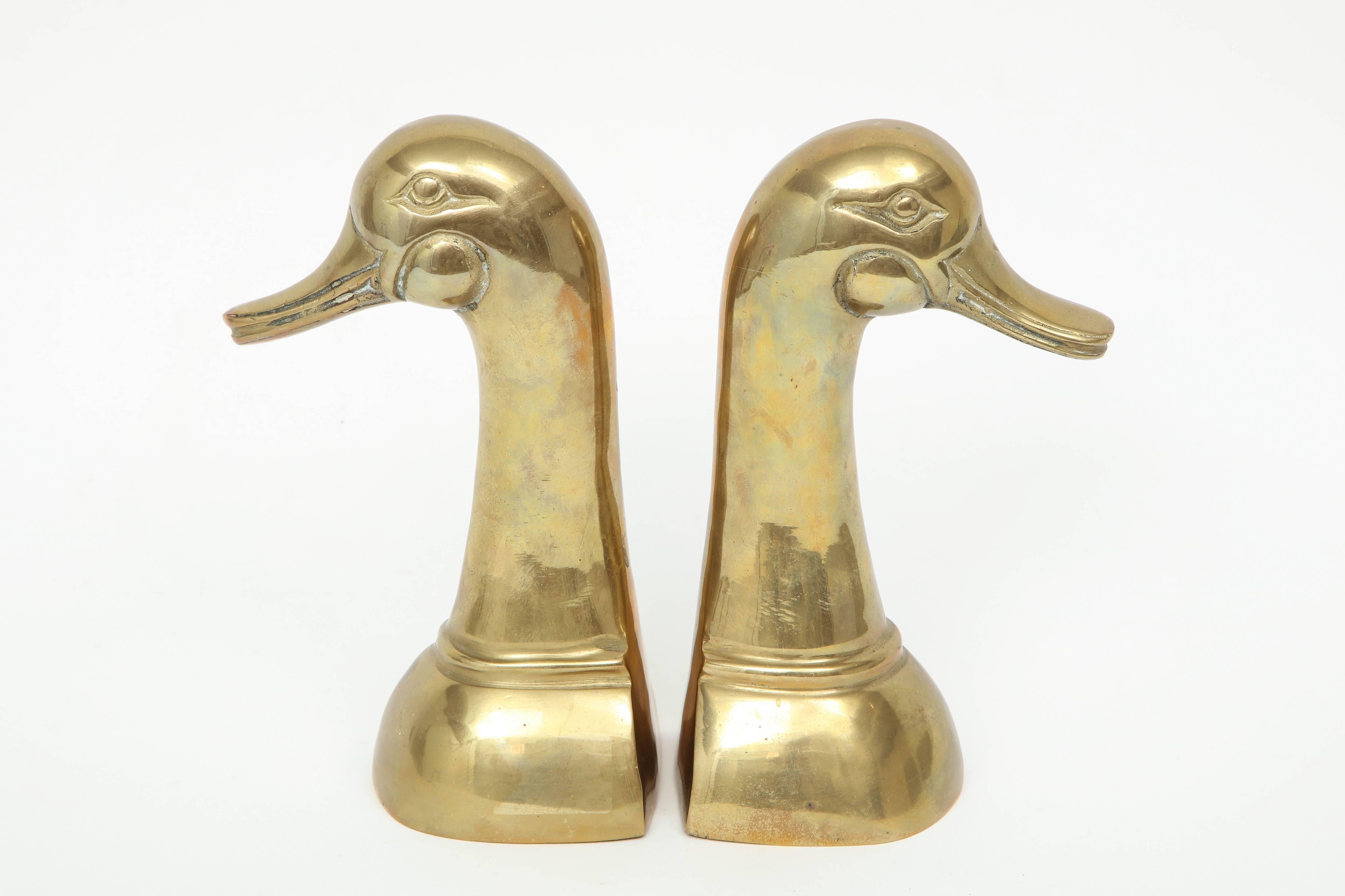 Pair of midcentury brass Mallard duck bookends with an aged warm glow patina.
