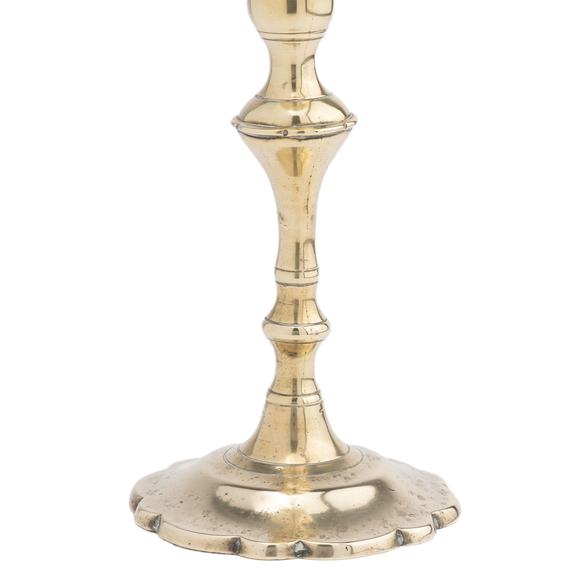 British Cast brass Queen Anne petal base candlestick, c. 1760 For Sale
