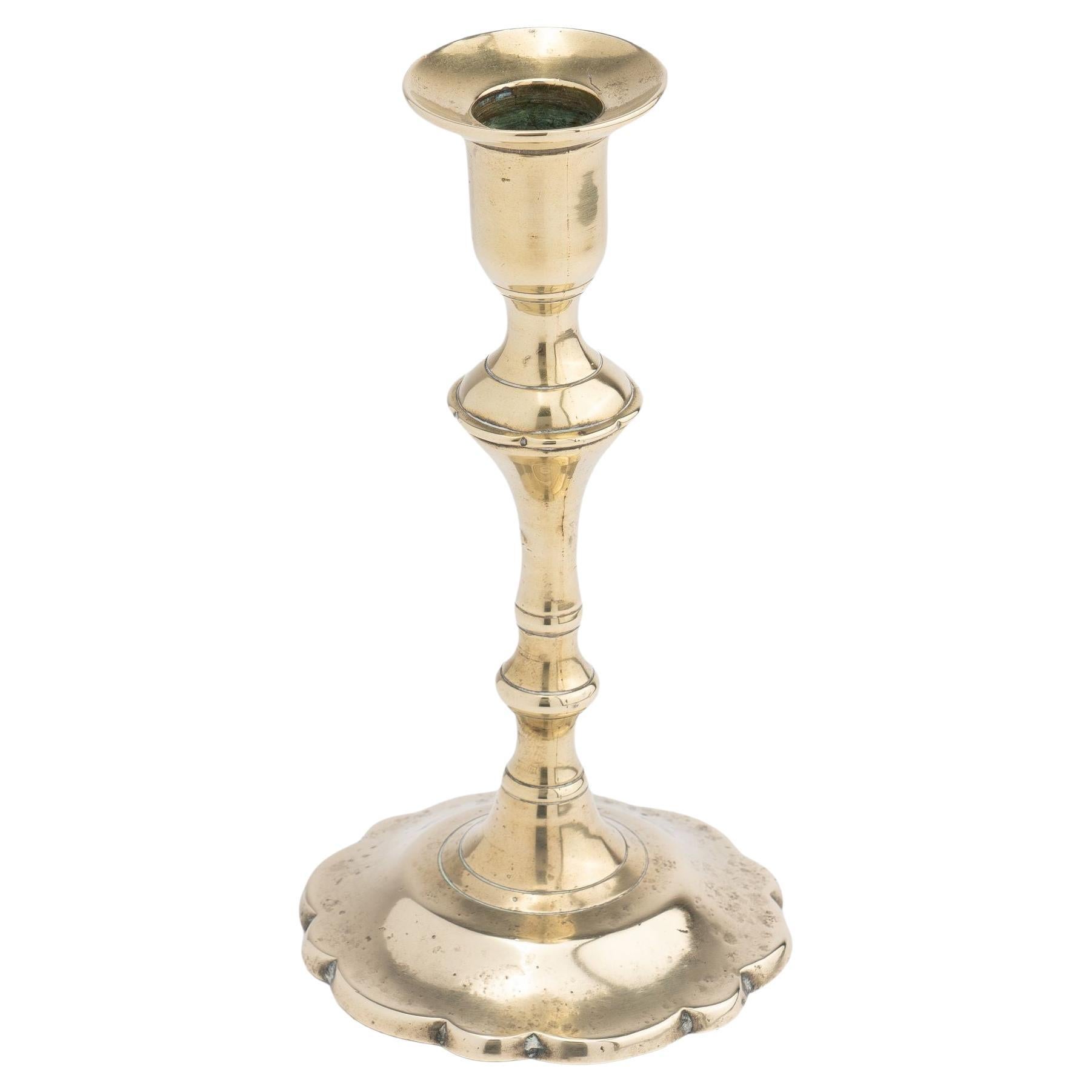 Cast brass Queen Anne petal base candlestick, c. 1760 For Sale