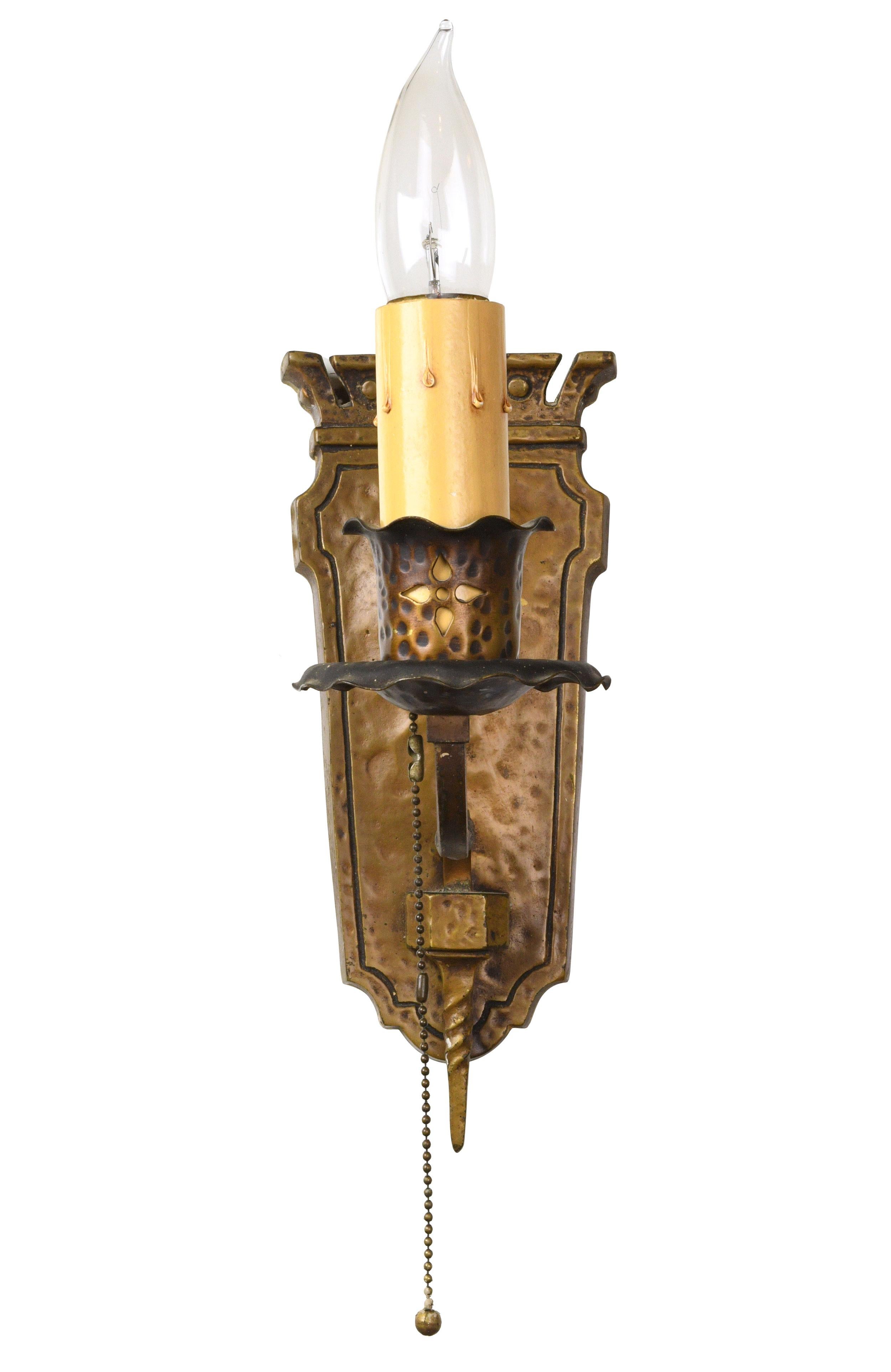 Beautiful, heavy cast brass Tudor sconce with hammered detailing throughout. The twisted metal arm and pronounced finial add a touch of elegance to this richly textured piece.

seven matching sconces available; sold separately.

circa