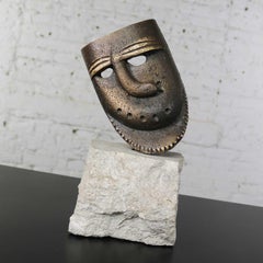 Cast Bronze African Mask Sculpture with Crooked Nose Mounted on Limestone Stand