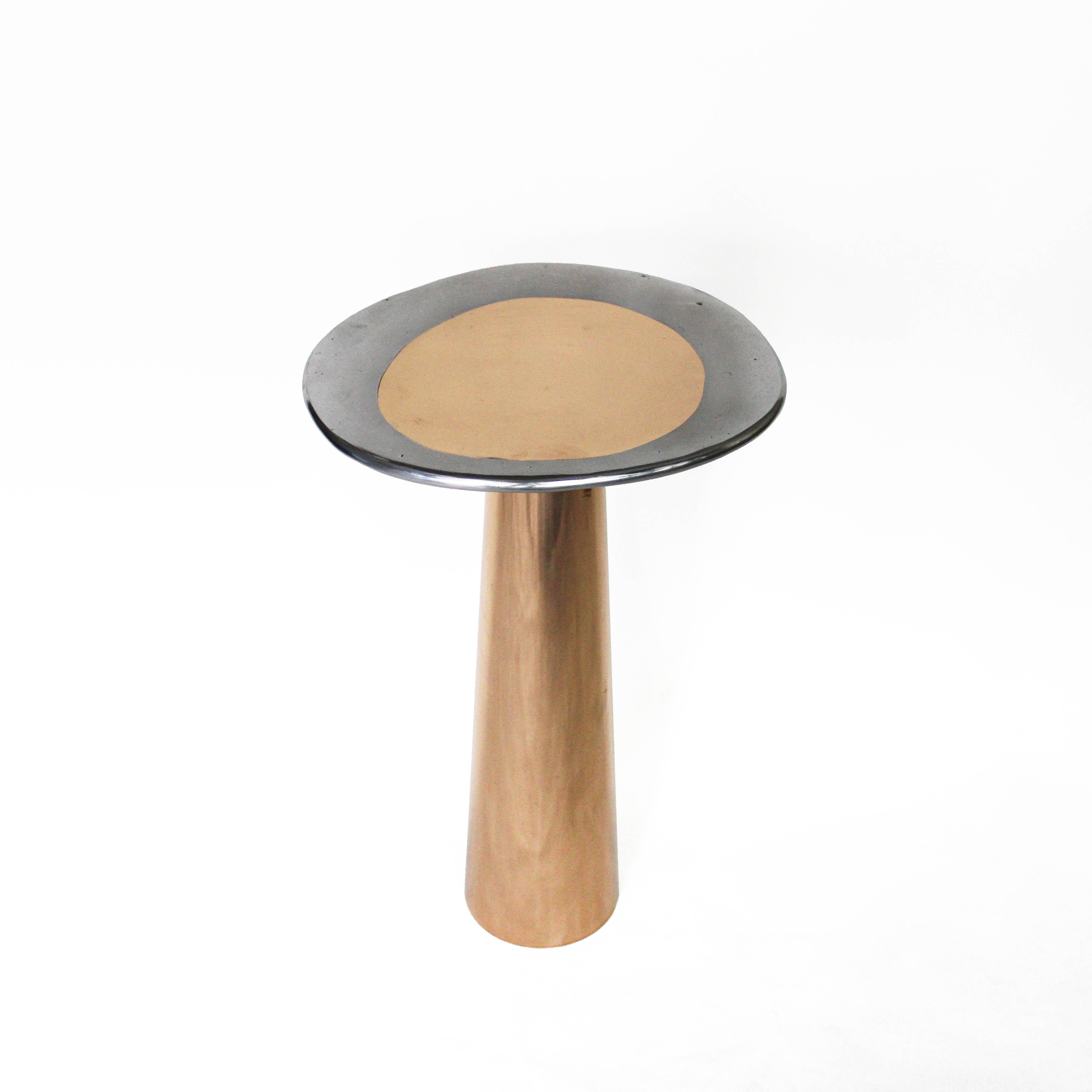 The Cone Table is inspired by the interconnections between the elements and life forms. The conical shape of the base, the asymmetrical form of the top, and the rounded edges provide the table with a silky appearance.

Cone Table, made of bronze or