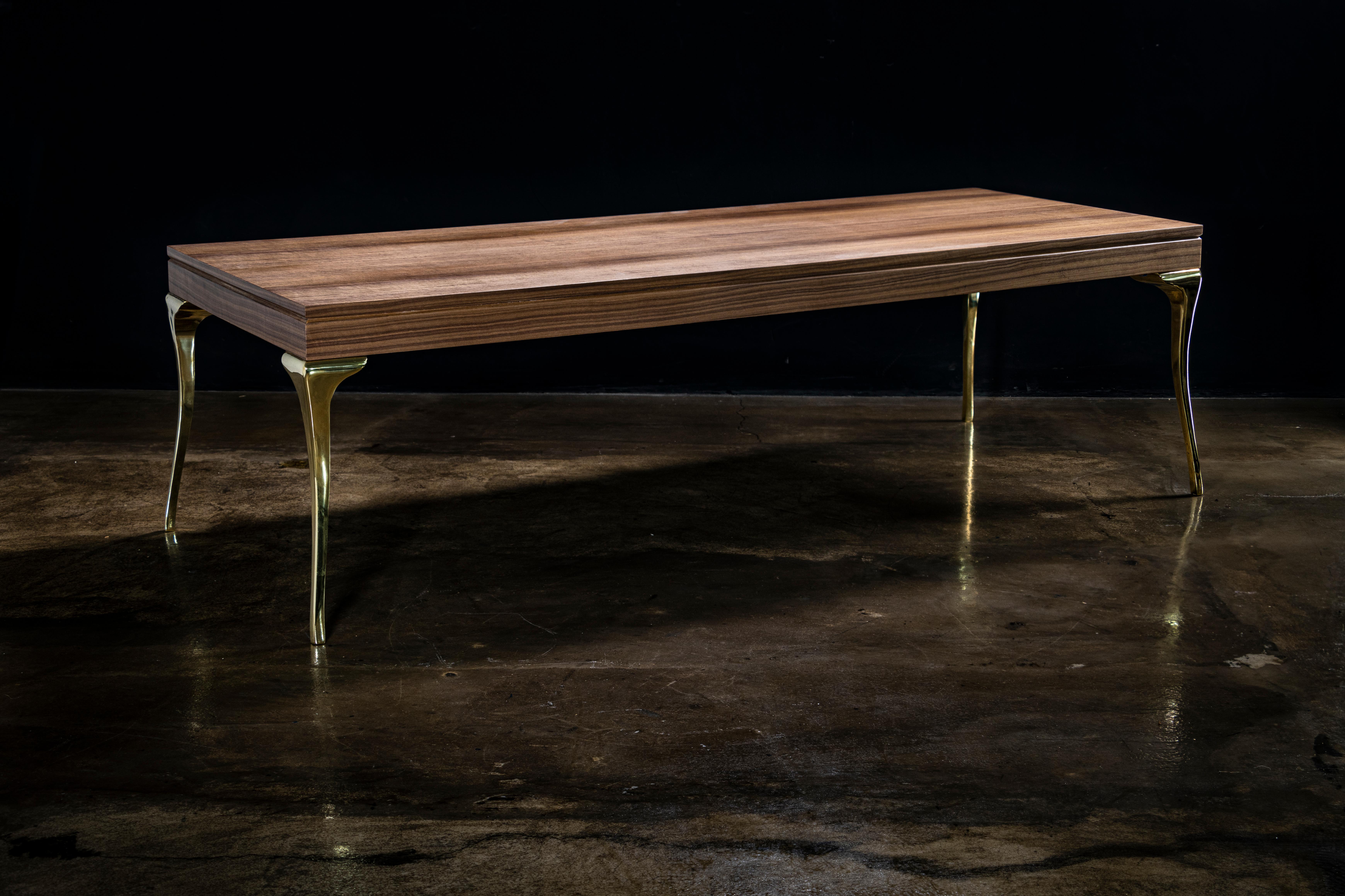 The Enzio Coffee Table features a modern take on a classic Queen Anne form in its cast bronze legs.  Available as shown with a walnut top, or in any size, shape or material including stone, metal, or other wood species and finishes.