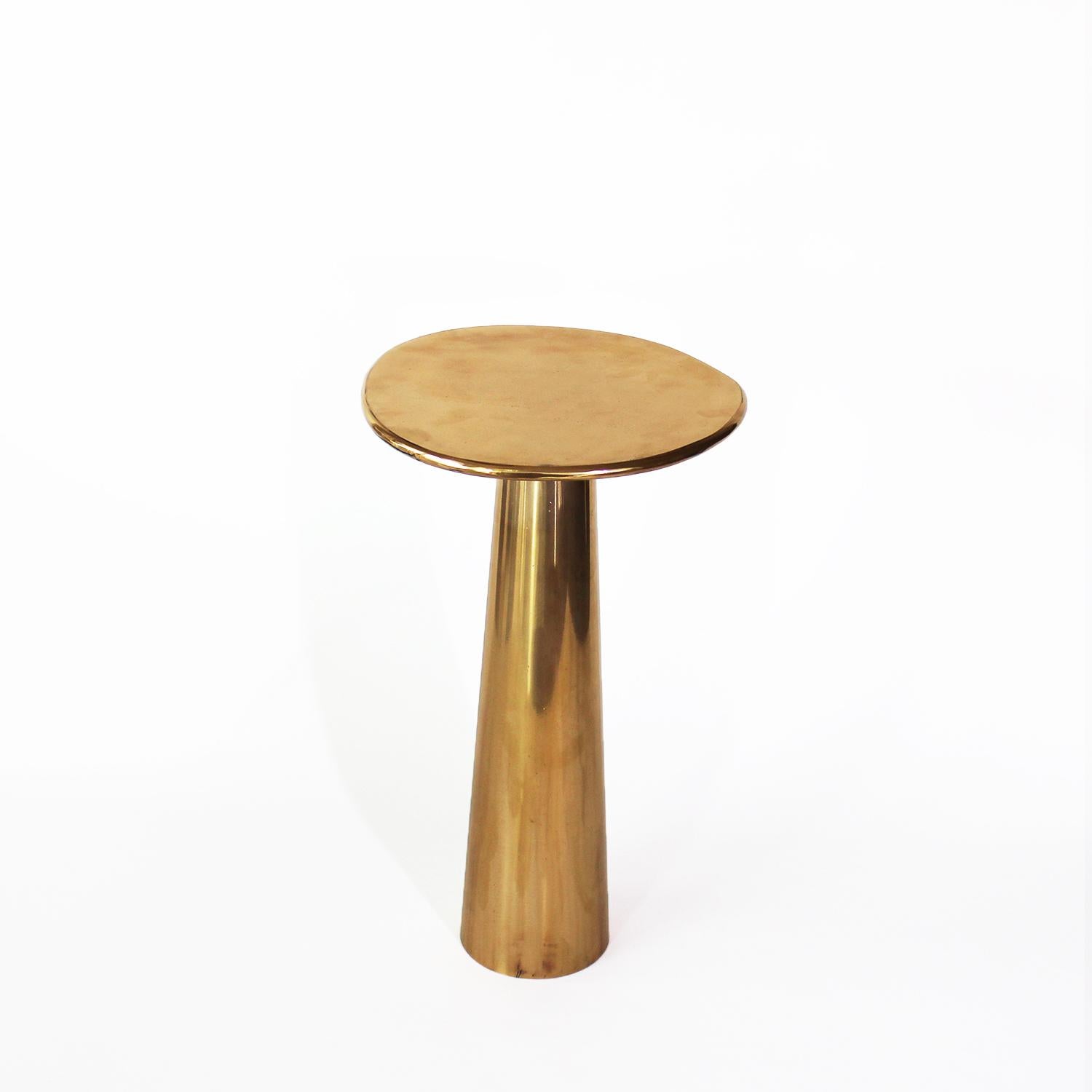 The Cone Table is inspired by the interconnections between the elements and life forms. The conical shape of the base, the asymmetrical form of the top, and the rounded edges provide the table with a silky appearance.

Cone Table, made of bronze