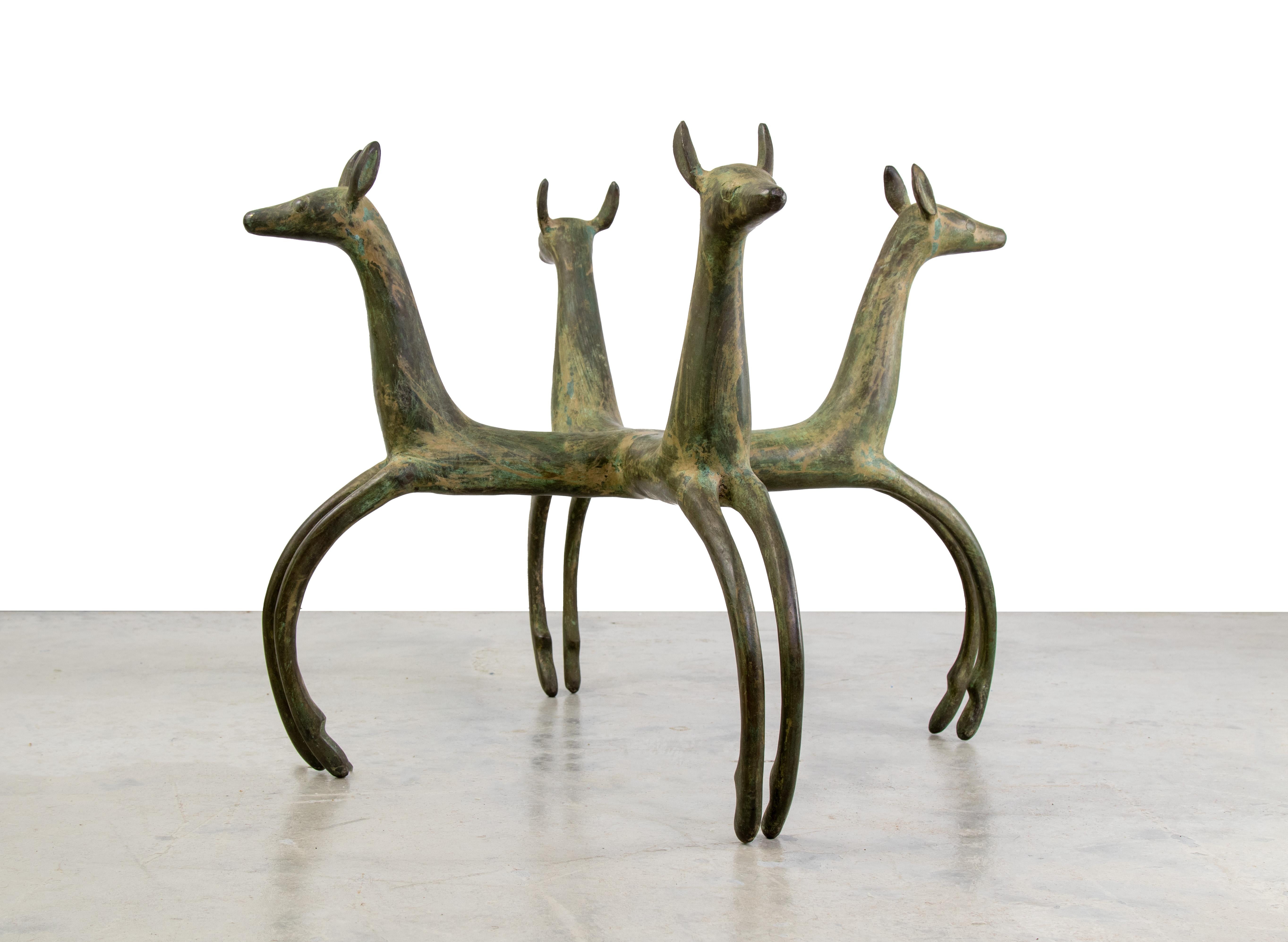 A deer form cast bronze table base in the style of Armand Albert Rateau. Shows great applied Verdi gris patina. This table base will be shipped without the glass top. A 1/4