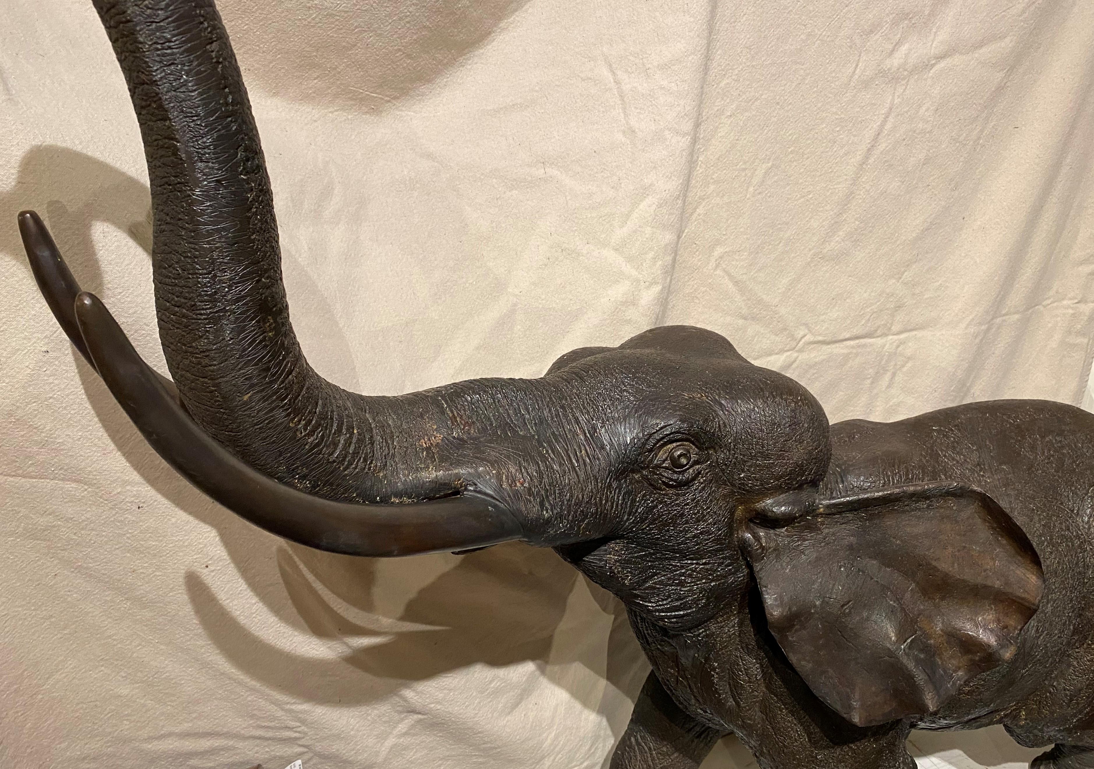 A fine patinated hollow cast bronze elephant of great proportion, with trunk up. The Asian elephant appears in various religious traditions and mythologies. They are treated positively and are sometimes revered as deities, often symbolizing strength