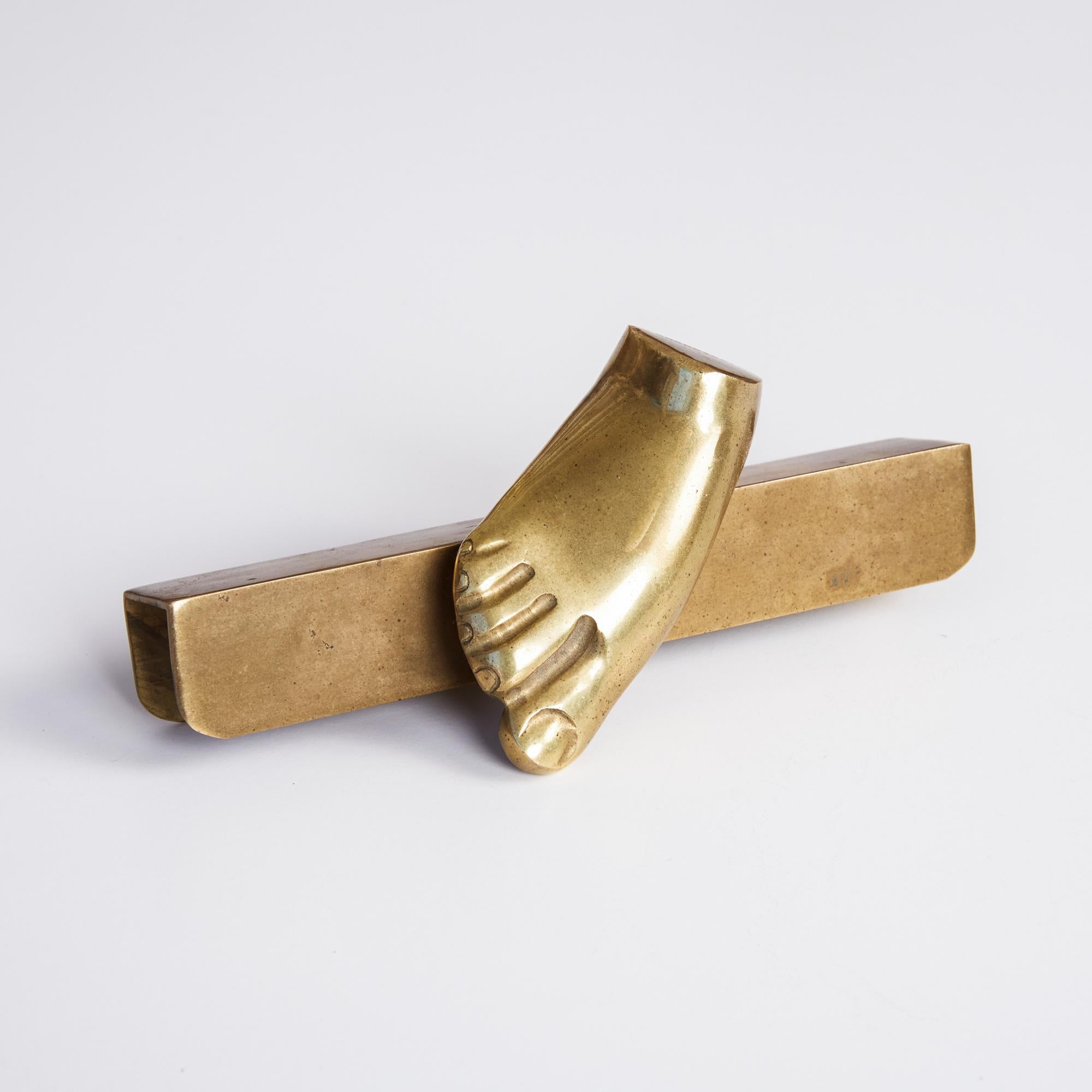 Cast bronze foot by Italian-Brazilian artist Pietrina Checcacci. The small weighted object features a bronze foot attached to a bronze mounting plate. This quirky furniture element would be the perfect way to accent a desk or shelf displaying