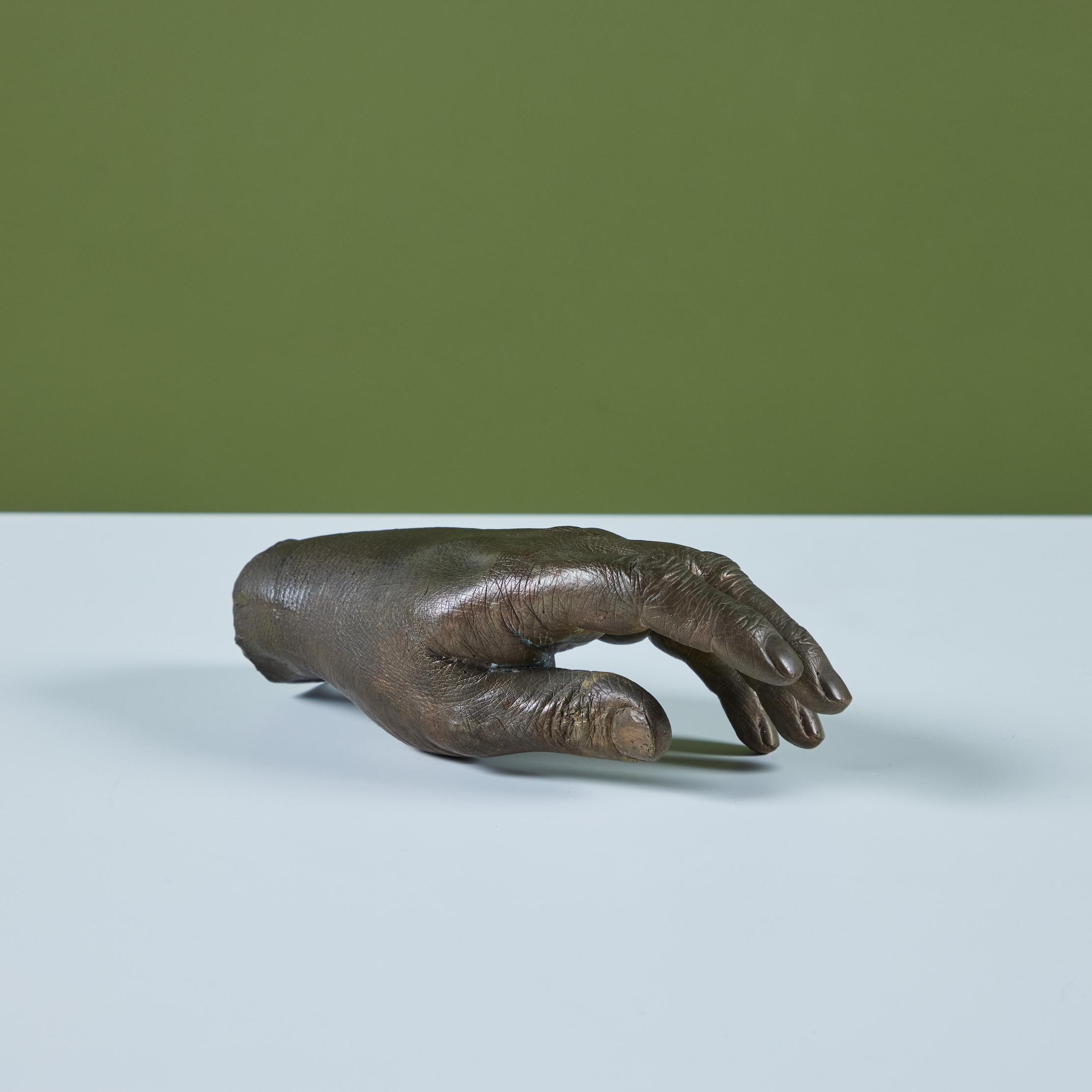 Cast bronze hand in the style of Pietrina Checcacci. The hand is hollow with many intricate knuckle and finger nail details. Crafted to perch on a flat surface and positioned as desired.

Dimensions
8.25