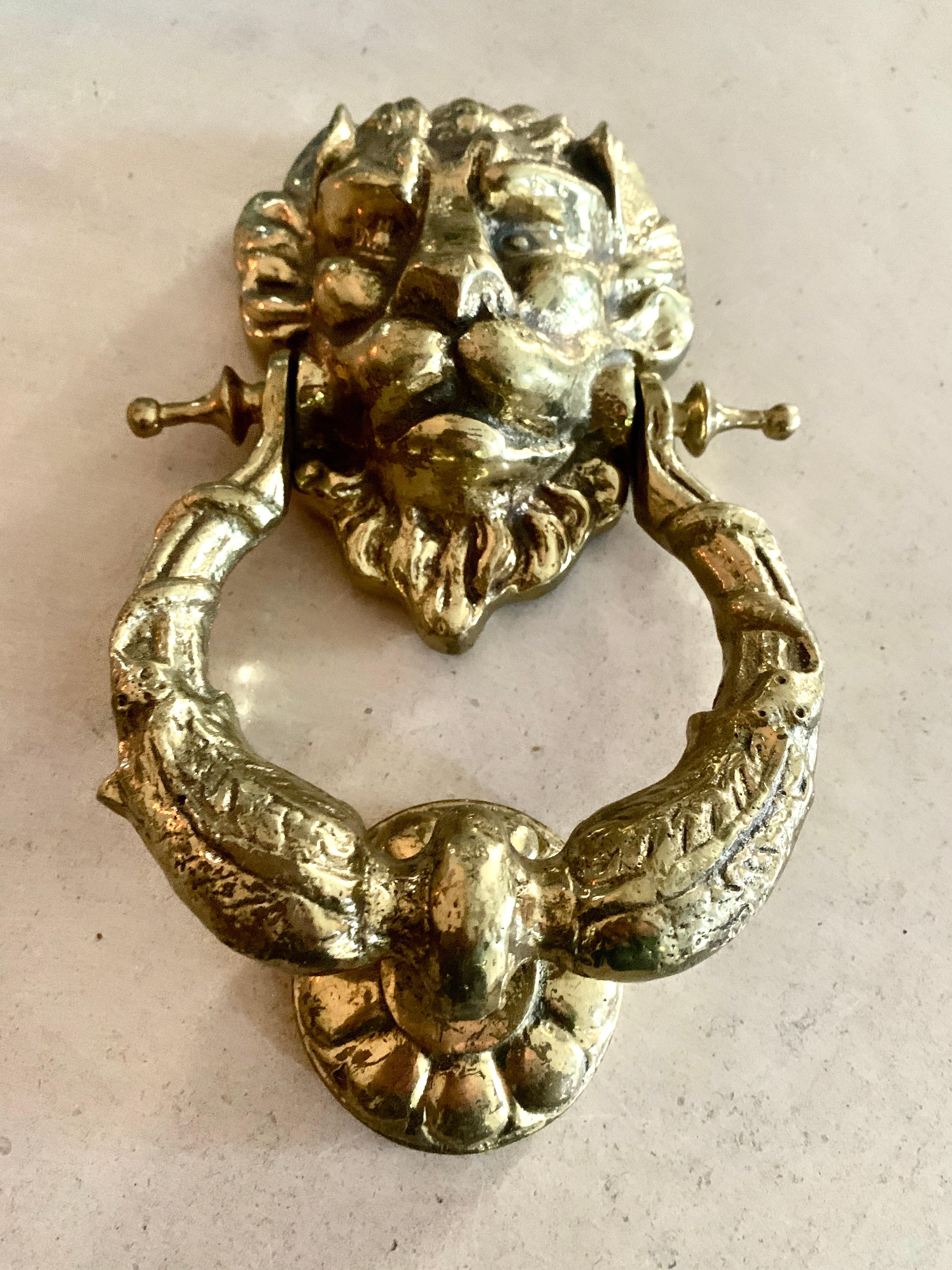Add style to your entryway with this Lion Knocker. The large size of this product ensures that the details are visible as guests approach the door. This door knocker is made of brass, a heavy-duty material that is will withstand the effects of