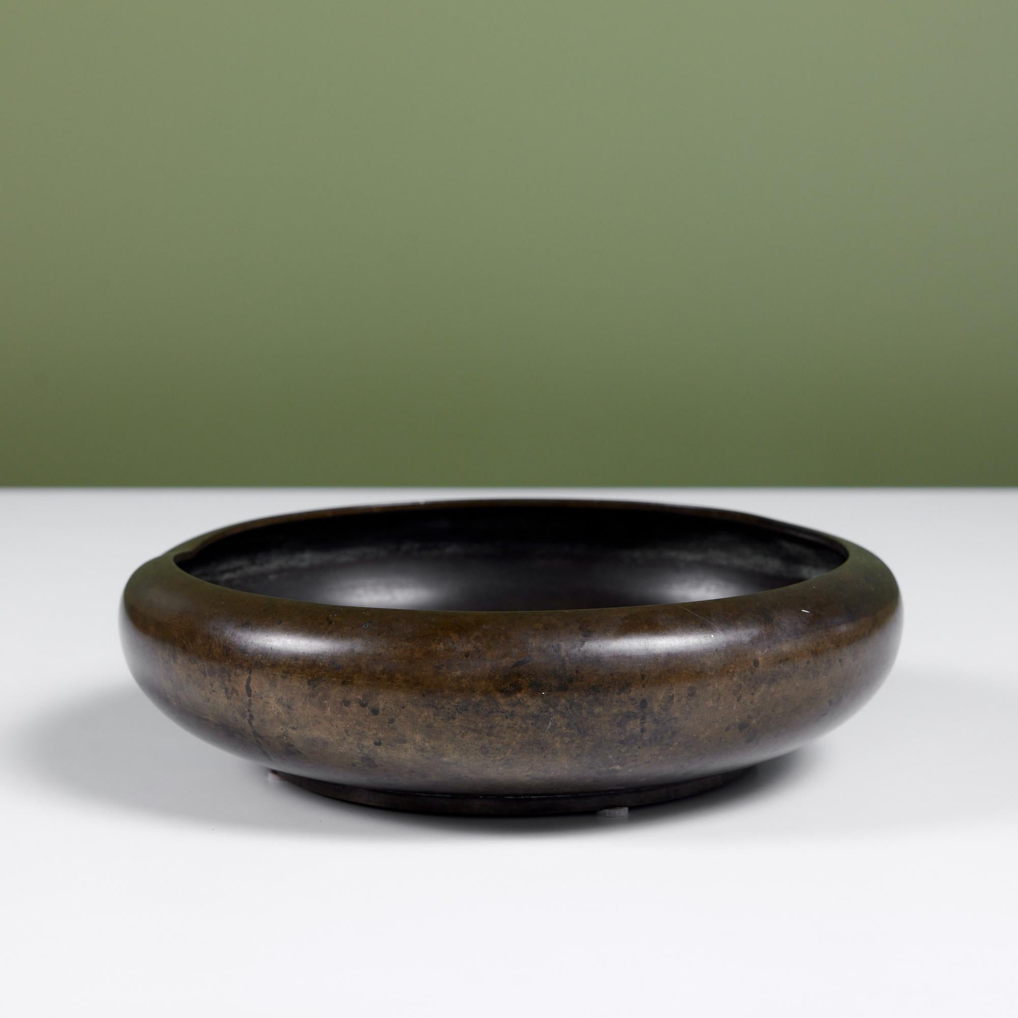 Wide patinated bronze bowl with a rounded lip and low profile. A perfect catchall for your pocket objects, or just a bold decorative piece.

Dimensions
10