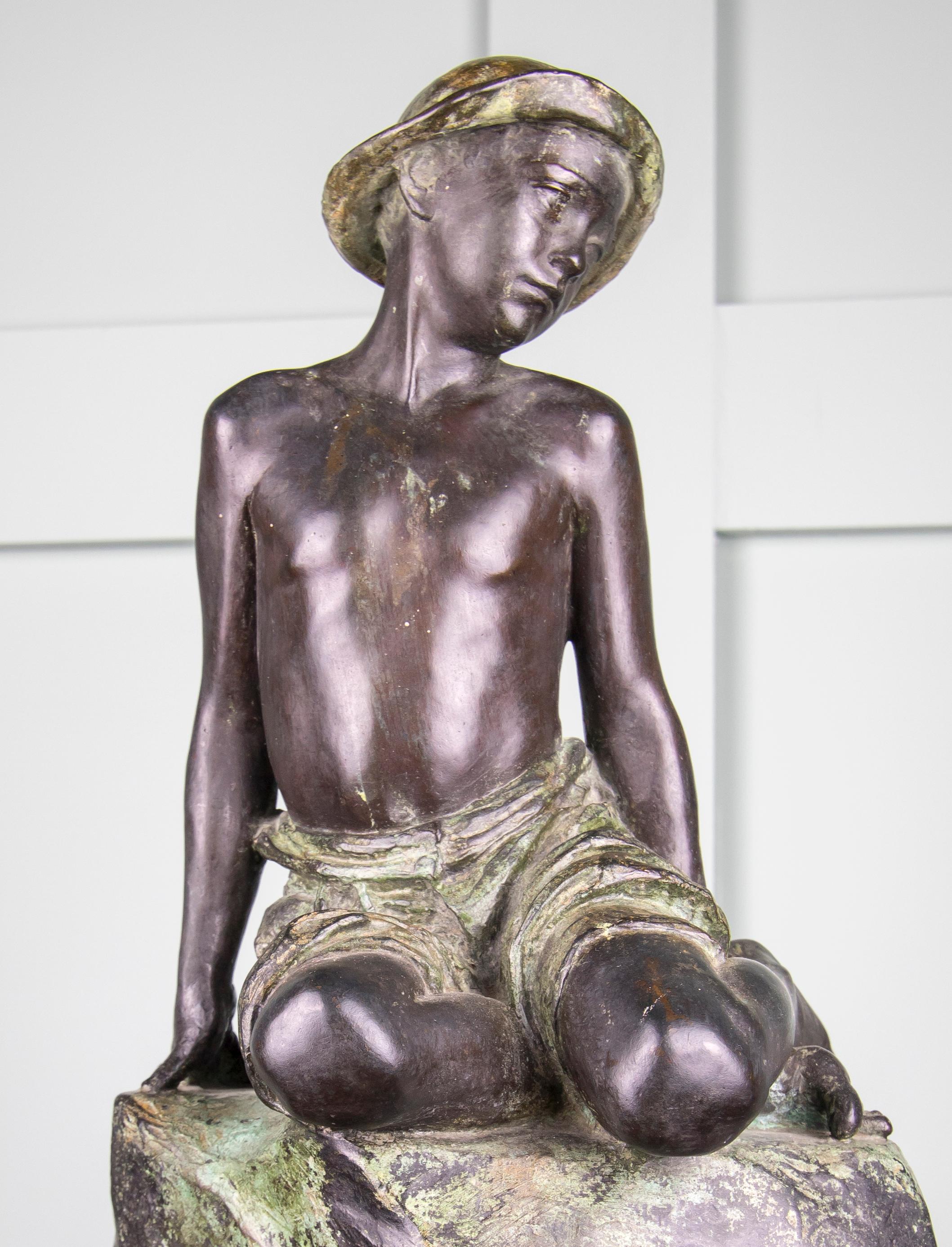 This very endearing bronze depicts a young male figure sitting upon a rock. Dated 1919 Roma with signature as seen in the images, unknown sculptor. Beautifully worked and in good condition.