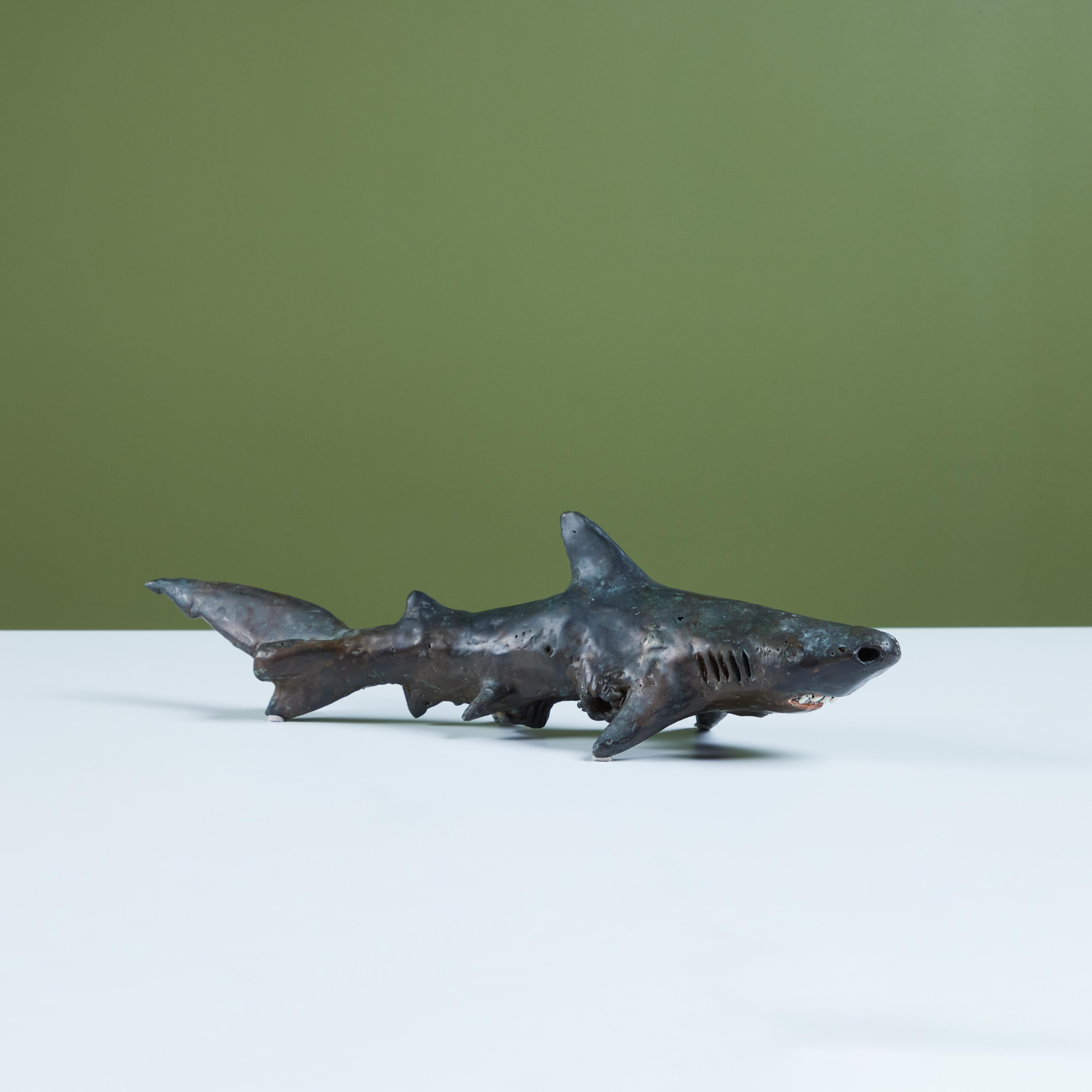 Cast bronze shark sculpture by American sculptor J. Dale M'Hall. 
James began sculpting in the 1960's and has worked with a variety of different media throughout his career but bronze sculpting is his preferred medium which expresses and conveys his