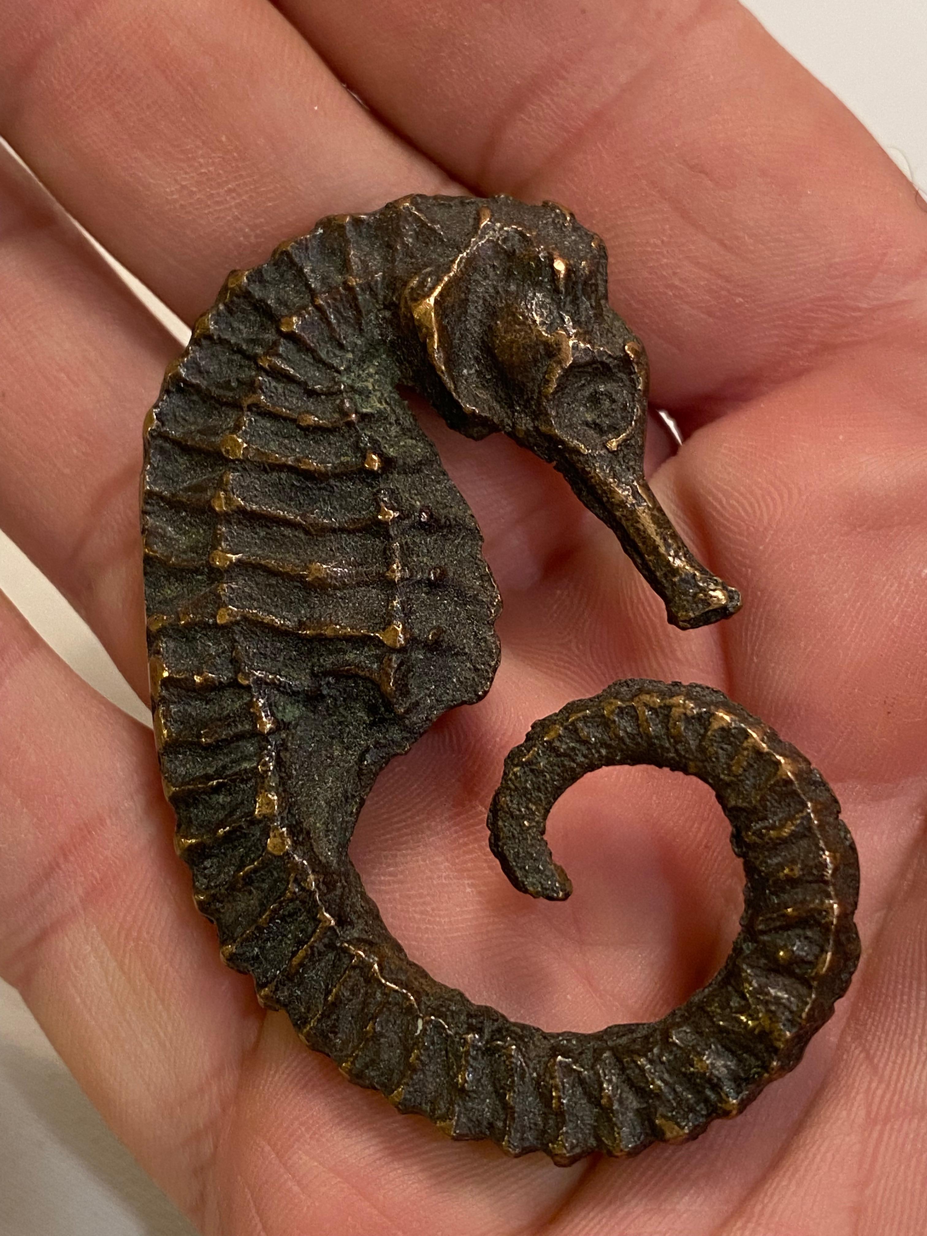 Tiffany Studios was producing some of the finest objet d'art at the turn of the 20th Century. A wonderfully realistic cast bronze seahorse by Tiffany Studios. The seahorse was a dominant design infatuation of the Art Deco period. The grace and