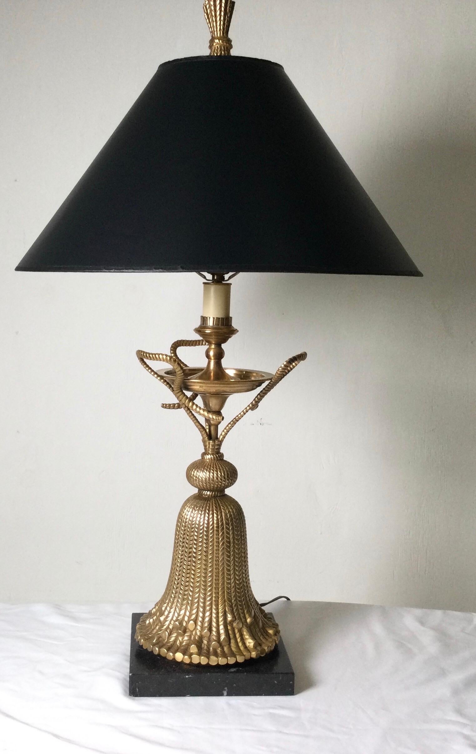 Whimsical cast brass table lamp in an oversized tassel form. The burnished bass finish gives a soft and warm golden brass color. The shade is for Photographic purposes only and not included with the lamp. The shade is for photographic purposes only
