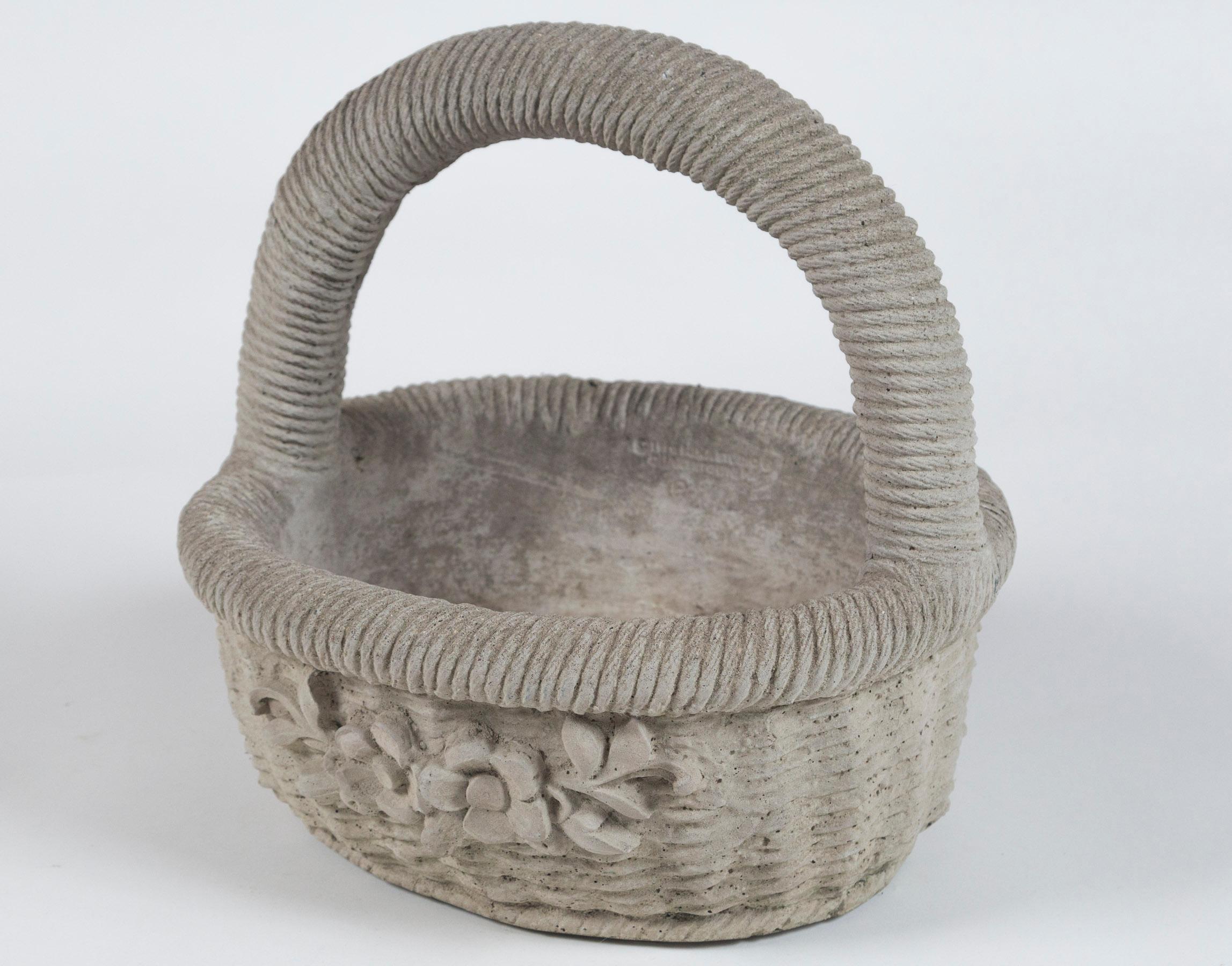 Cast cement garden basket, 20th century. Nicely detailed with overall woven rattan design and floral relief.