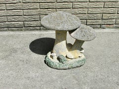 Cast cement mushrooms with frog yard art sculpture