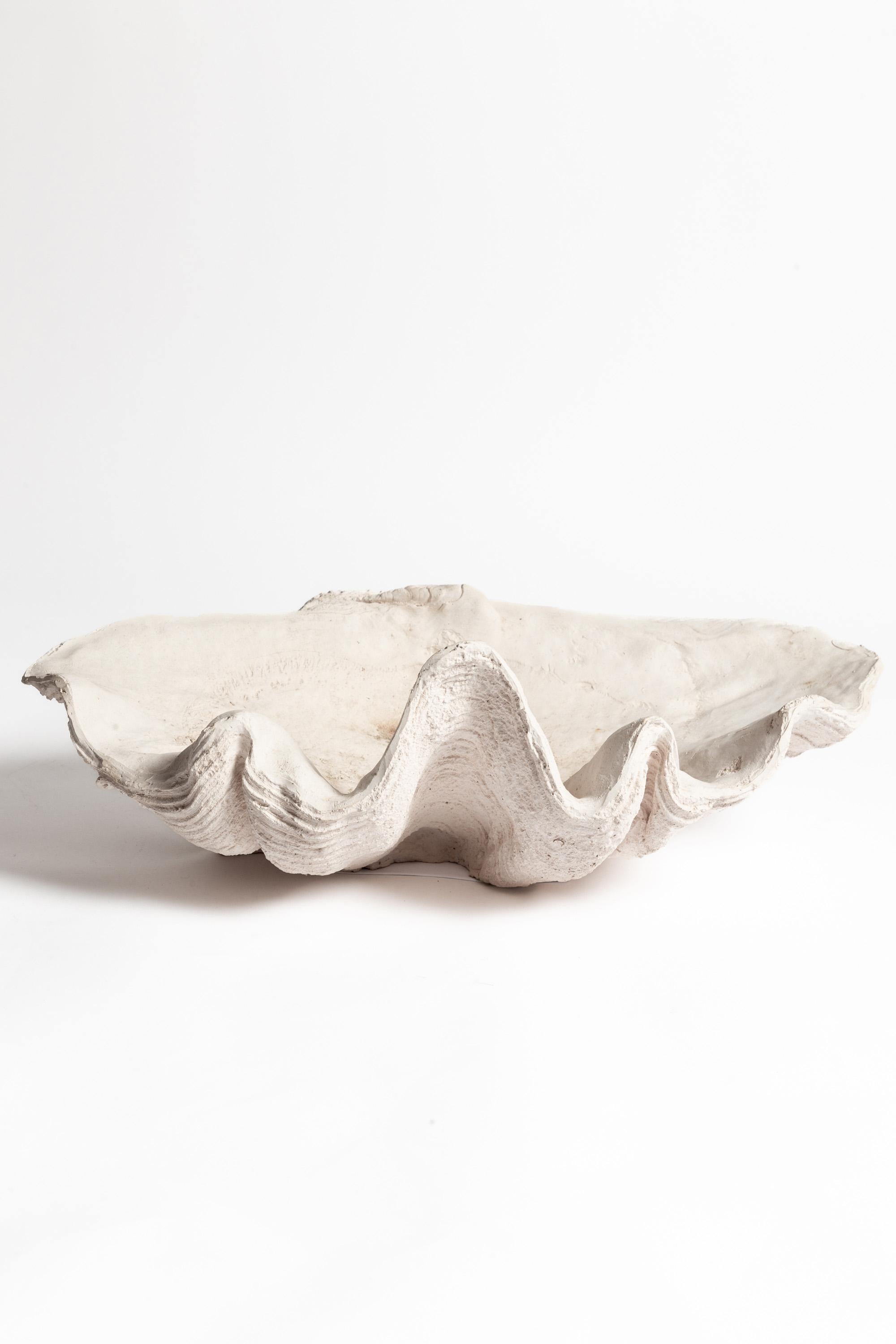 A 20th century cast giant clam shell. Weathered condition.