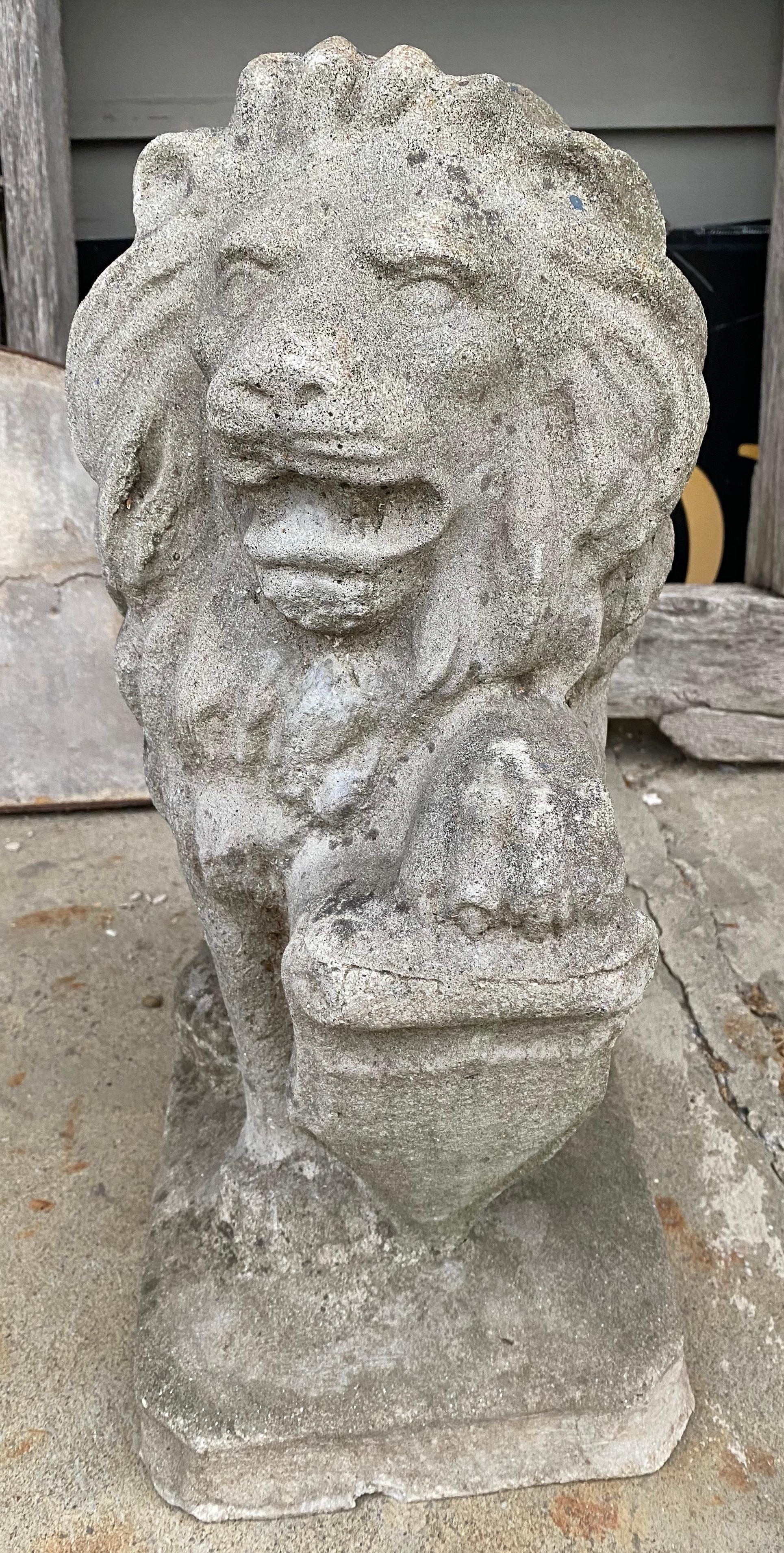 Very handsome 1950s seated cast concrete lion with paw on shield.
 