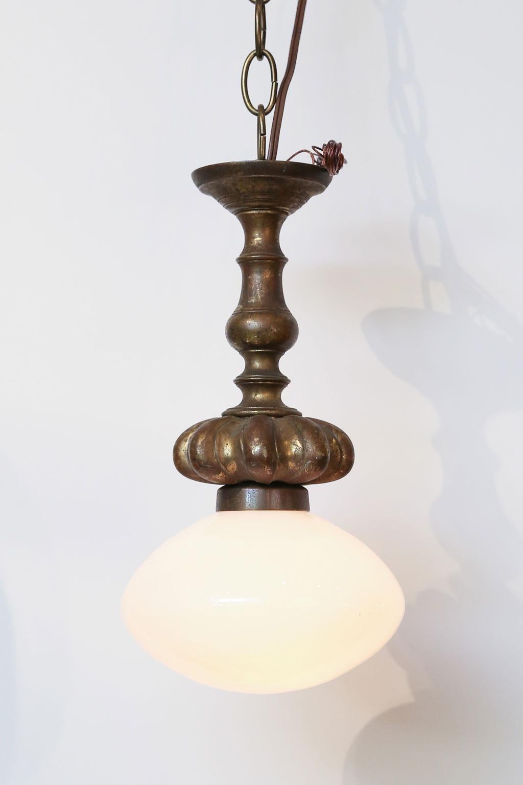 Cast French bronze fixture from the early 1900s with a single light covered by an antique ovoid hand blown milk glass globe. Newly wired for use within the USA. The bronze is beautiful and heavy.  the light is simple and elegant and would make a