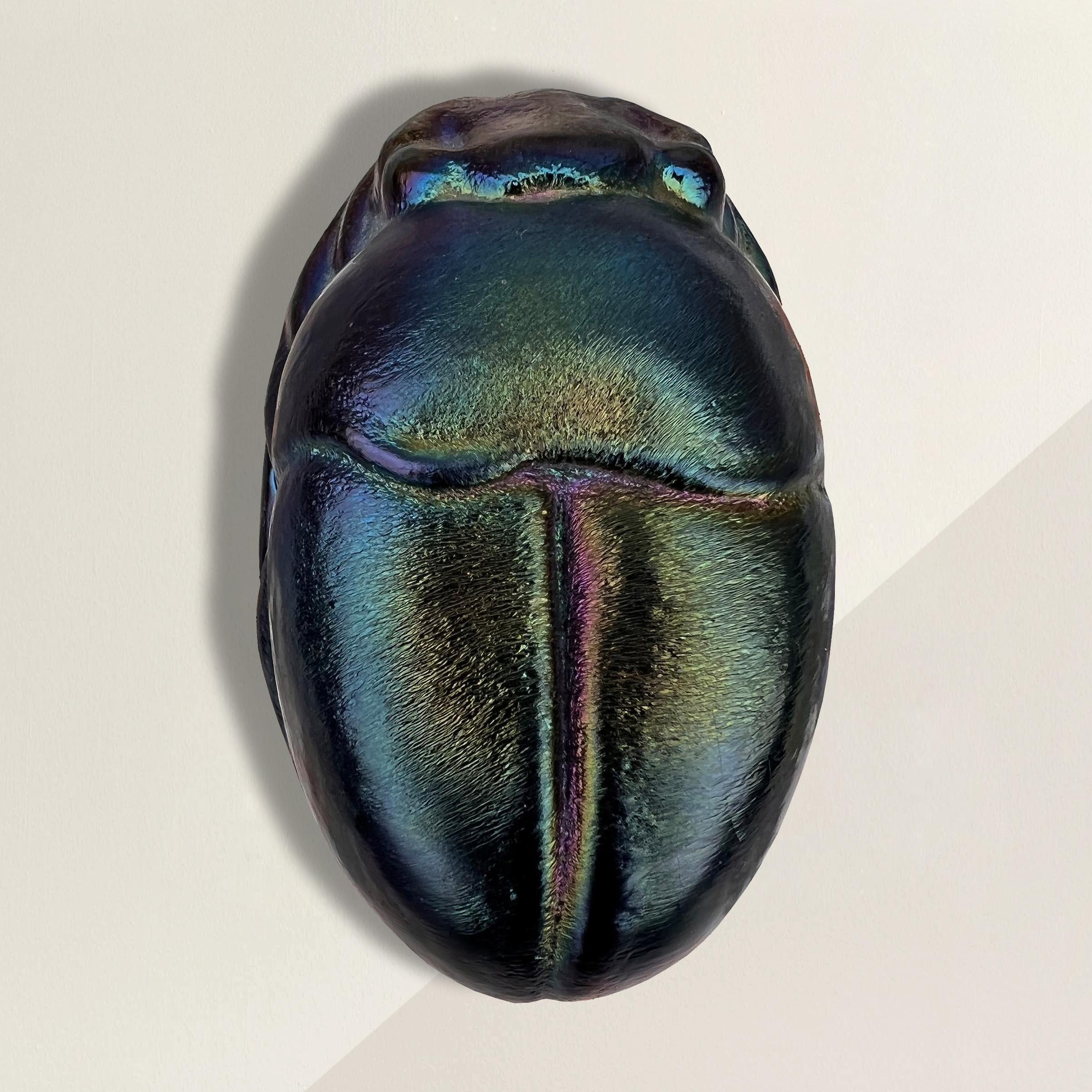 An incredible 20th century American cast glass scarab beetle with the most beautiful iridescent color and a texture to die for! In ancient Egypt, scarab beetles were harbingers of immortality and rebirth, and were believed to protect against disease