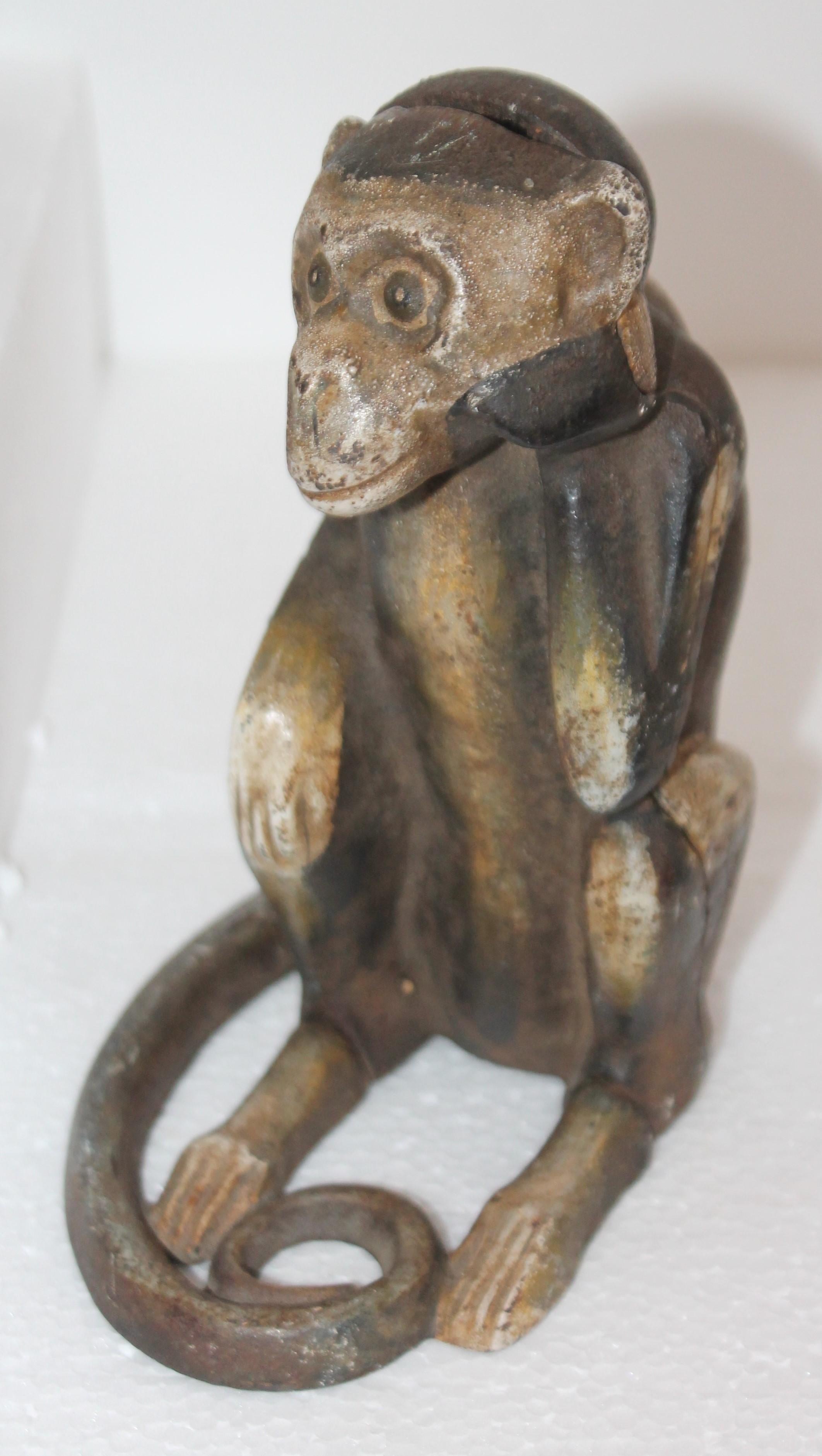 This fine original painted monkey bank / door stop is very heavy and works both ways. It could work as a bank or a door stop. The condition is very good with fantastic untouched surface.