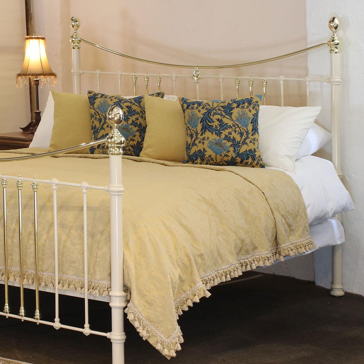 Cast iron and brass bed finished in cream with curved brass top rails and decorative central Art Nouveau plaque. Adapted to the 6'0 width from an original Victorian frame. 

This bed accepts a UK Super King or Californian King Size (6ft, 72 in. or