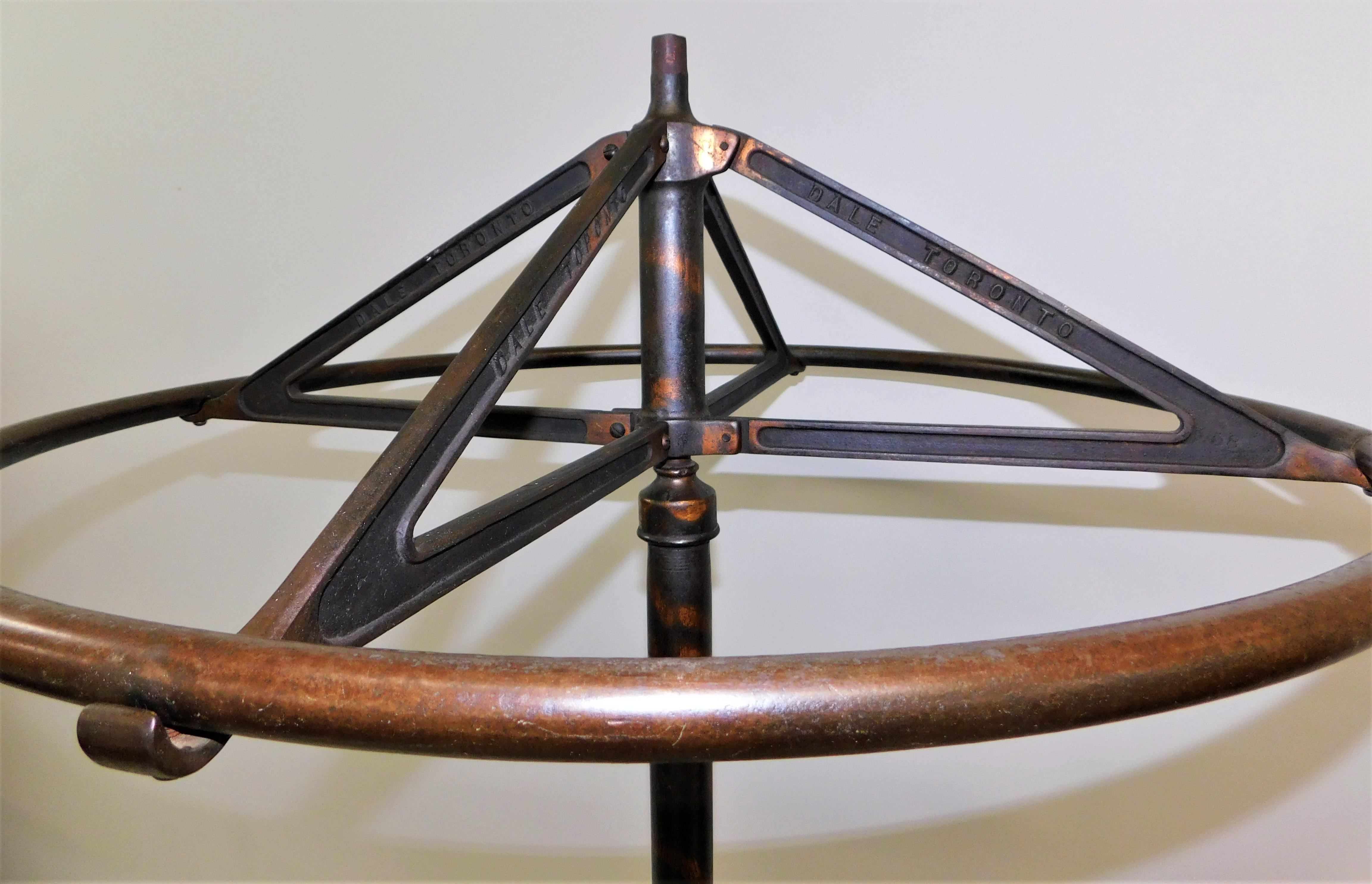 Victorian circular rail revolving coat rack made by the Dale Mfg Co Toronto Ontario Canada, circa 1900. Attractive detailing on the base with rolling wheels, strong cast iron construction with Japanning steel design.
Clothing not included, for
