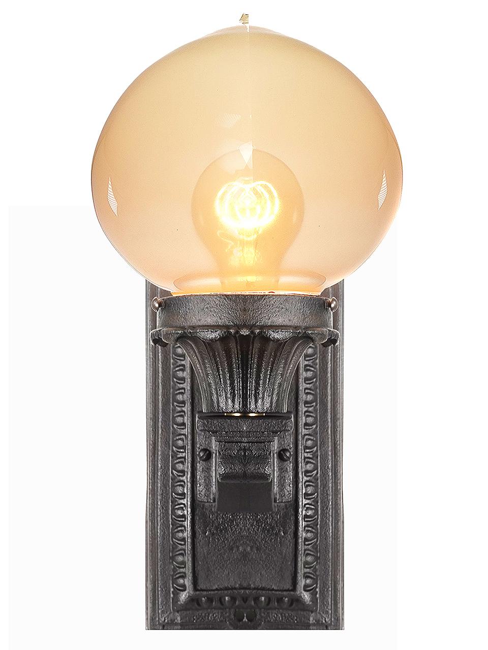 We have a collection of these original cast iron wall bracket sconces in stock. This is a classic design that we refinished and rewired. The hand blown tipped globe is  nice contrast to the dark iron finish. These look equally good pointing up or