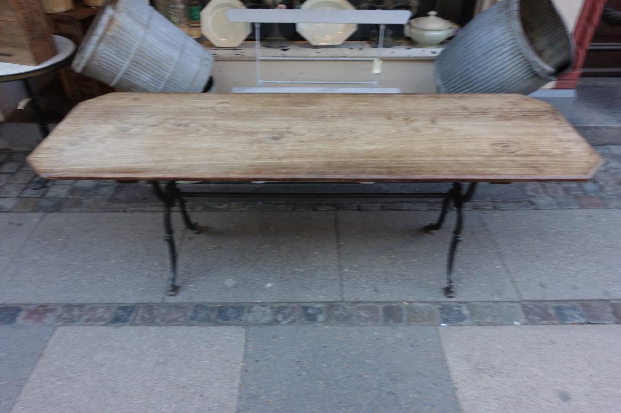 Charming and slim French bistro table, with a gorgeous cast iron under frame and thin elegant wooden tabletop. Has a warm patina. Provenance – a dining table at a traditional French bistro or café. Would be super as a console table in a living space