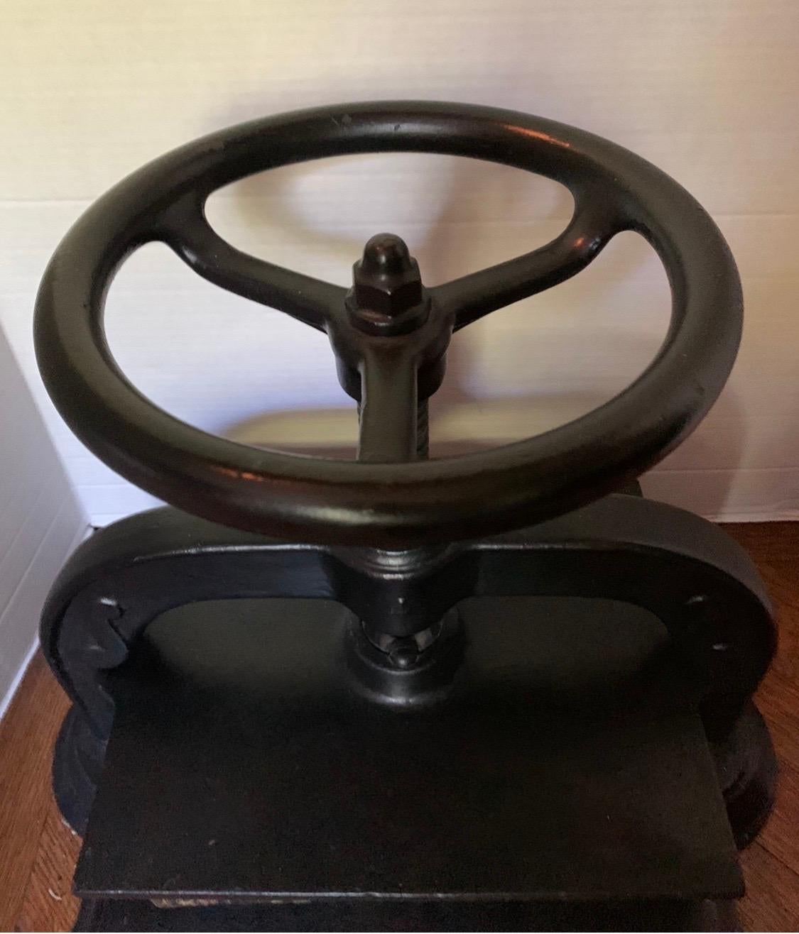 Rare antique cast iron book press used for bookbinding, flower pressing, scrap booking and various other arts and crafts. Has a functional screw-down top-plate.  Best used, in our humble opinion, as an object of art. Heavy, weighs about 50 lbs.