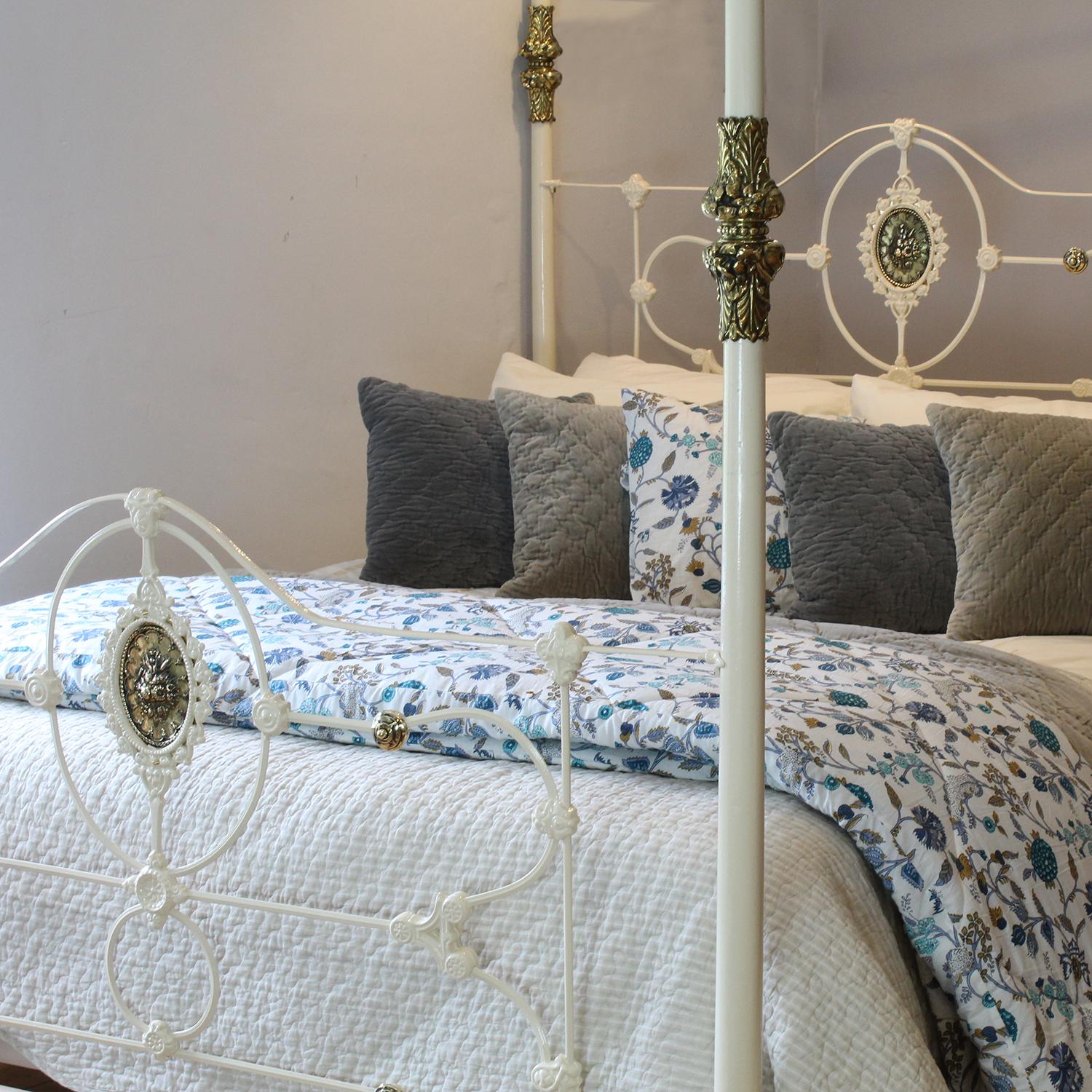 A 5ft wide cast iron antique four poster bed in cream with ornate castings and original brass decoration. 

The bed was originally manufactured in Birmingham, United Kingdom, towards the end of the Nineteeth Century and made for the export