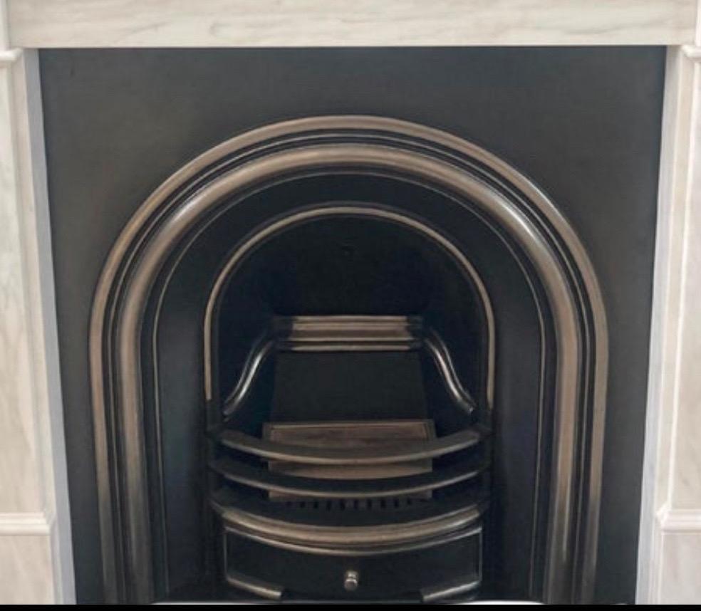 Cast iron arched fireplace insert. 
Highlight polish. Complete with bars, grate and damper flap.
Size: 38x38x12 inches. 