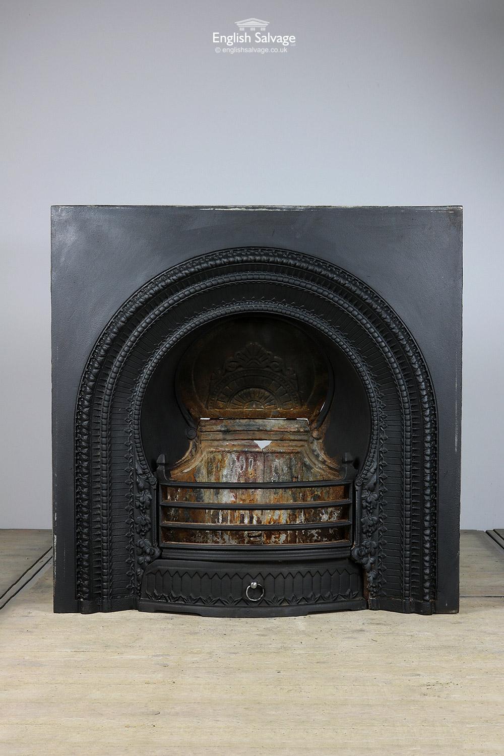 Reclaimed detailed cast iron fire insert with chimney plate and grate. Overall size below. A break in the metal to the rear needs attention and some surface rust is present.