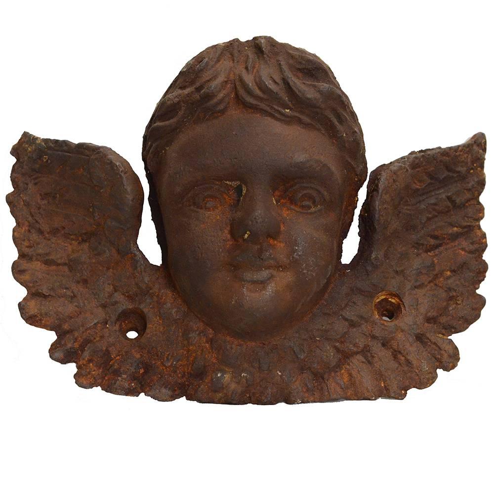 Reminiscent of the cemetery iconography popularized in the late 18th century, the cherub’s head nested between two wings symbolizes divine wisdom and justice; the cherubim are the guardians of the Tree of Life and sacred places. These beautiful and