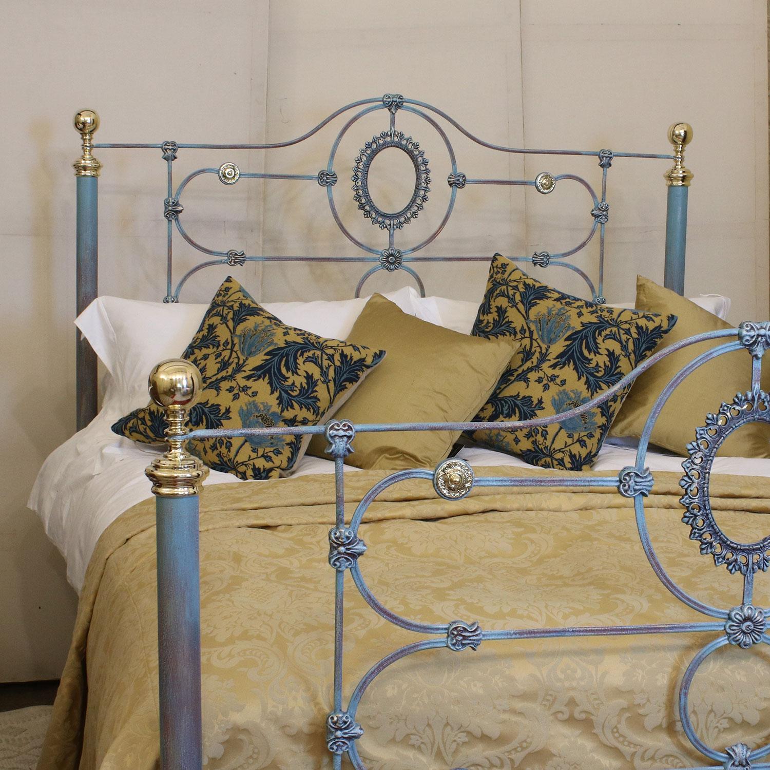 Mid Victorian cast iron bed finished in blue Verdigris with decoratively cast panels.