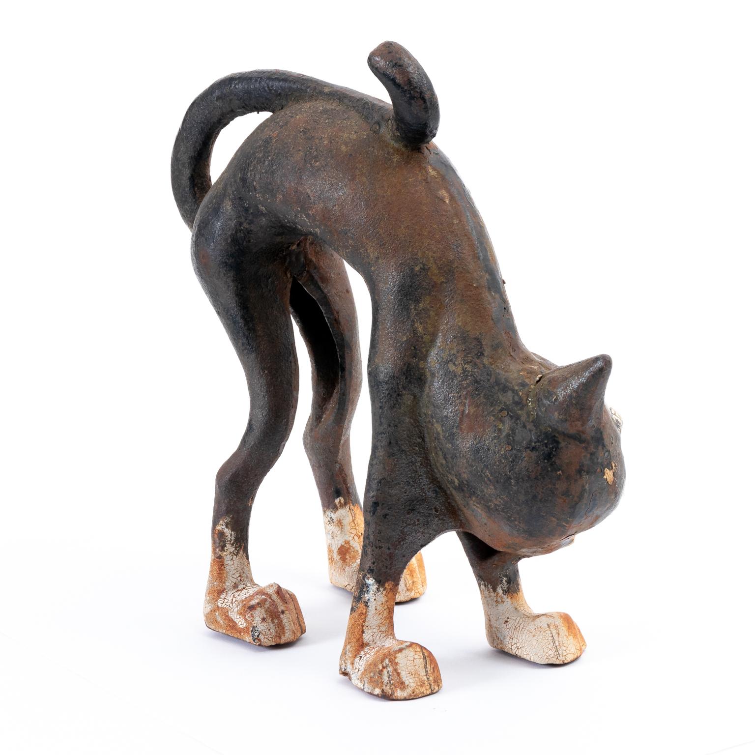 Original cast iron black cat door stops by the Hubley Company with original paint and patina, circa 1920-1930s. The cat is depicted with an arched back and expressive face. Please note of wear consistent with age including minor paint wear, paint