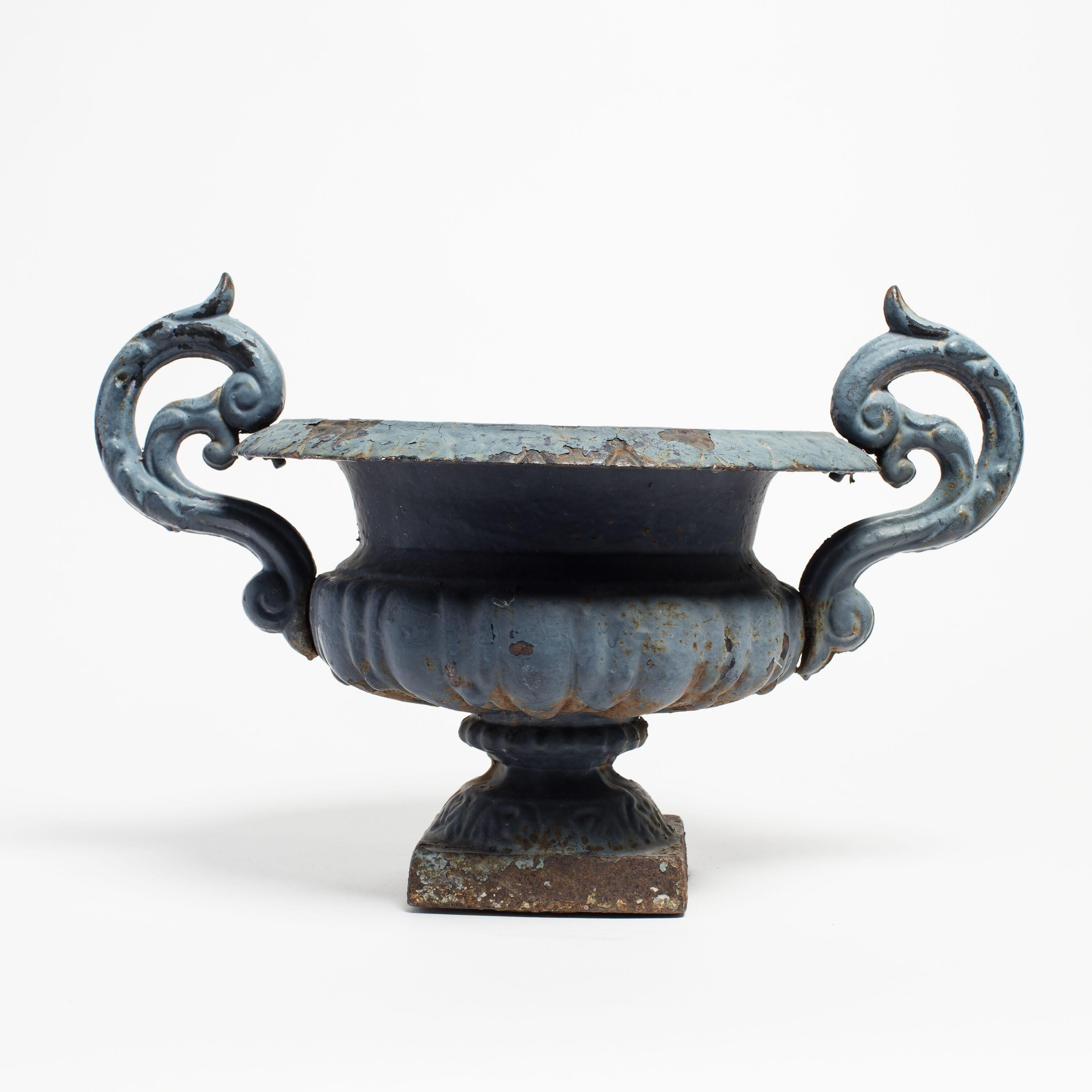 Neoclassical cast iron pedestal urn, made in France circa 1880. Striking blue enamel finish with a patina from age and weathering. This traditional garden element is ideal for elevating greenery. Discovered in the private collection of a dealer in