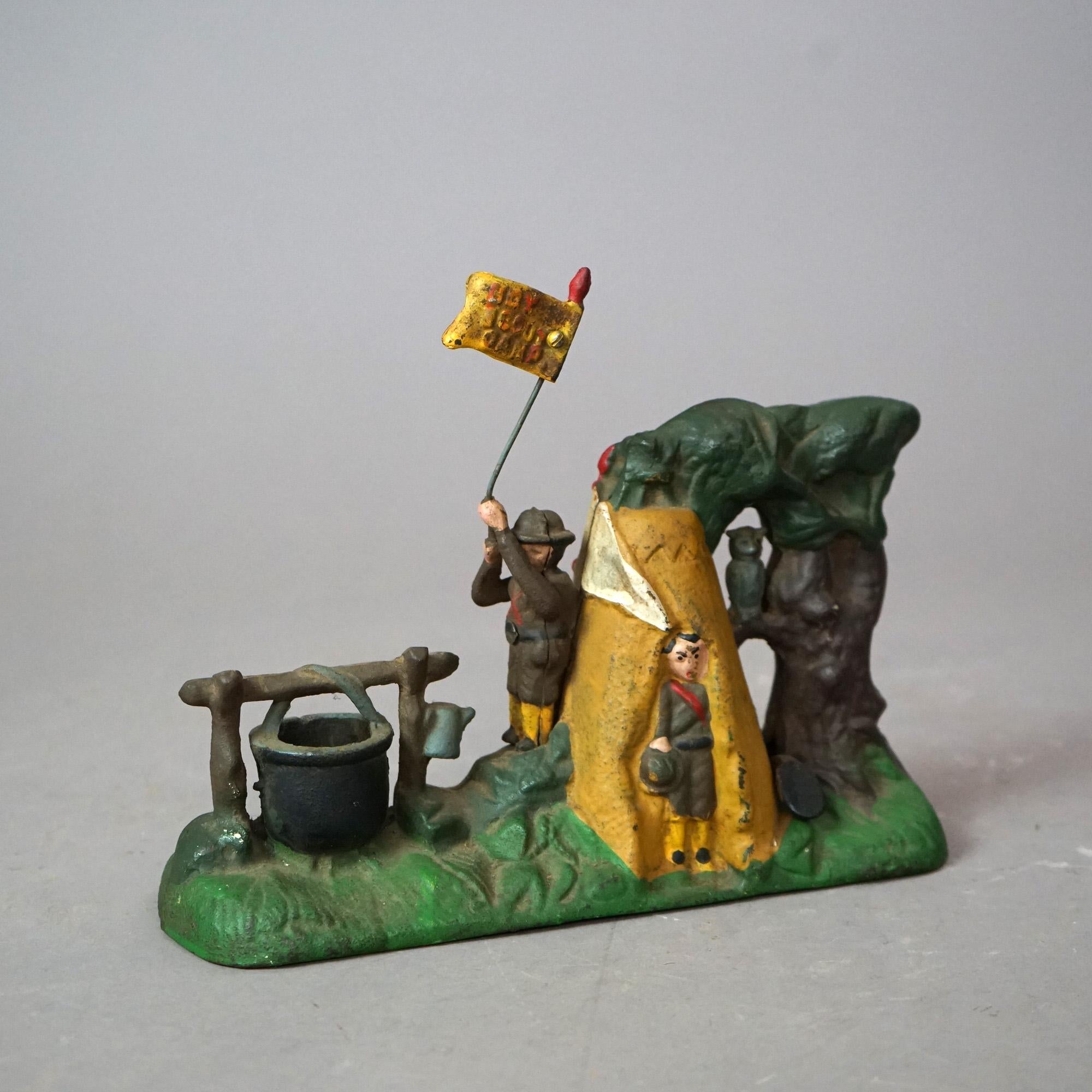 A painted cast iron mechanical bank offers Boy Scouts in an outdoor setting, 20th

Measures- 6''H x 3.5''W x 9.5''D