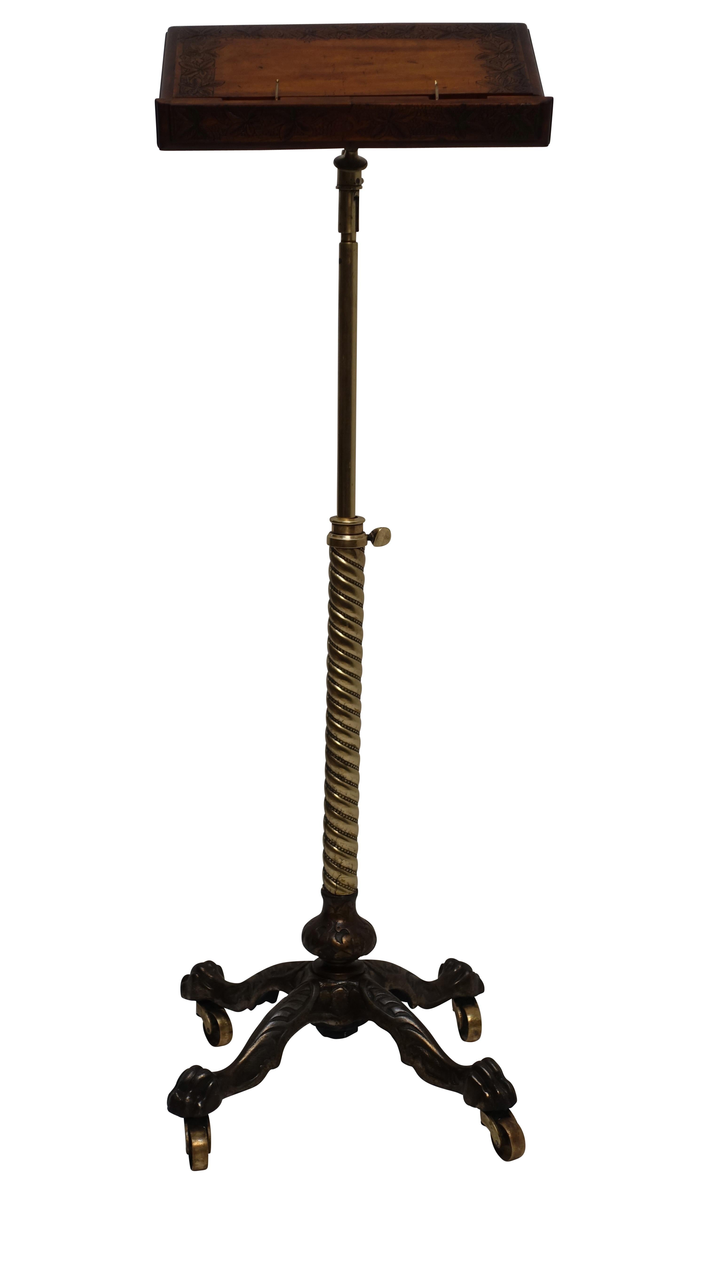 A fancy bookstand, podium, or music stand, having a cast iron base attached to an elaborate brass standard, supporting a hand carved walnut book platform with a swing out brass page holder, American, late 19th century.
The maximum height the stand