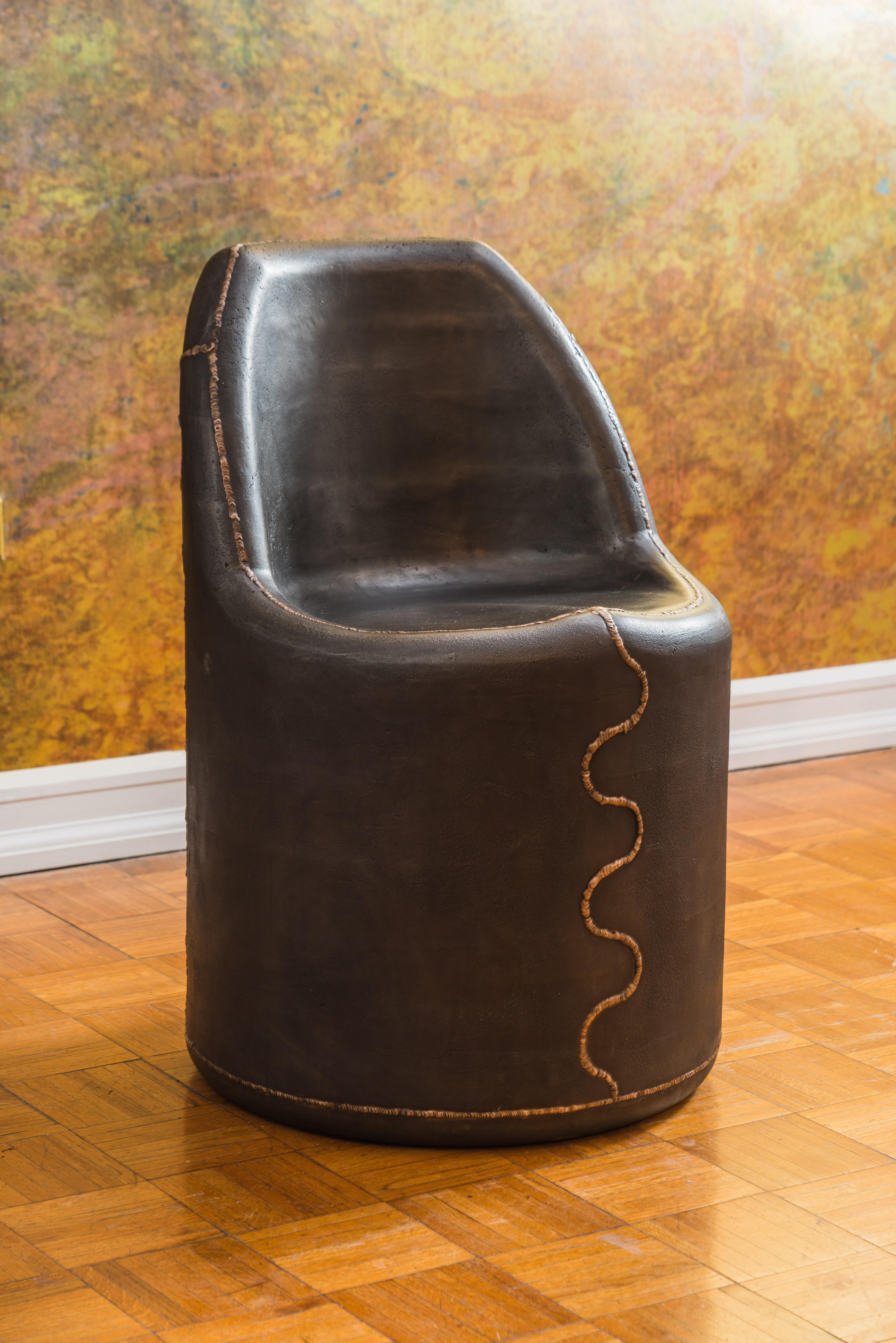Earthy and grounded cast iron chair with striking Kintsugi-inspired bronze 